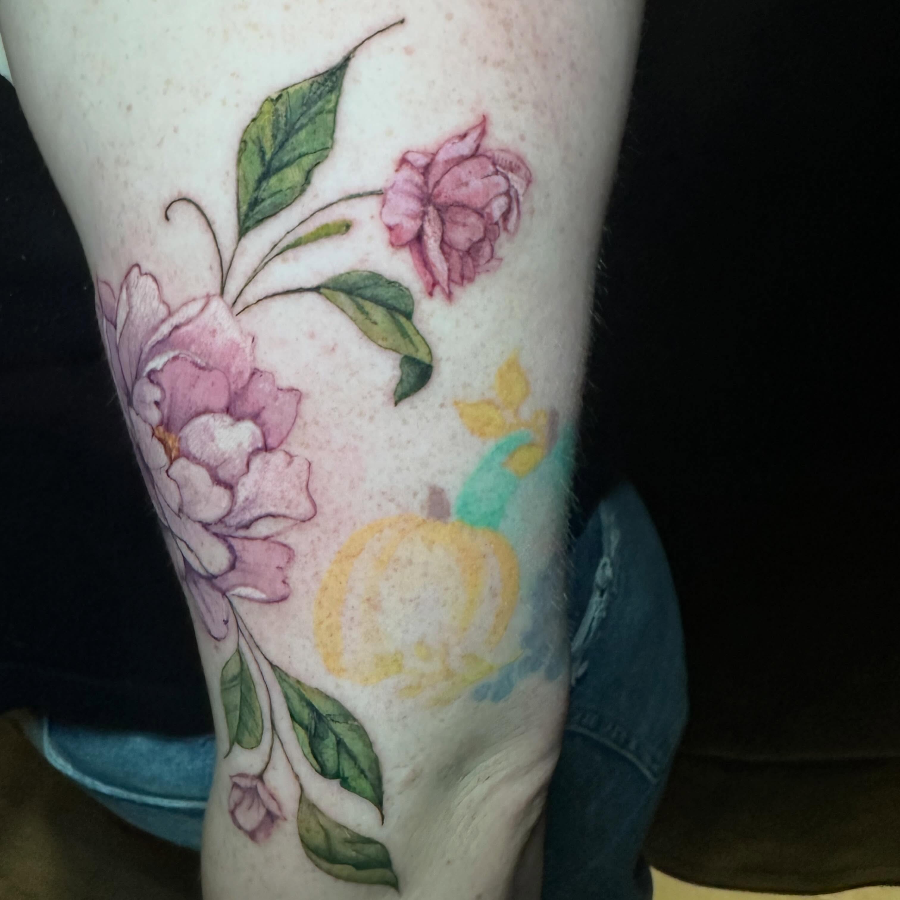 Floral arrangement watercolor tattoo on the forearm by Sam, Mount Laurel, New Jersey