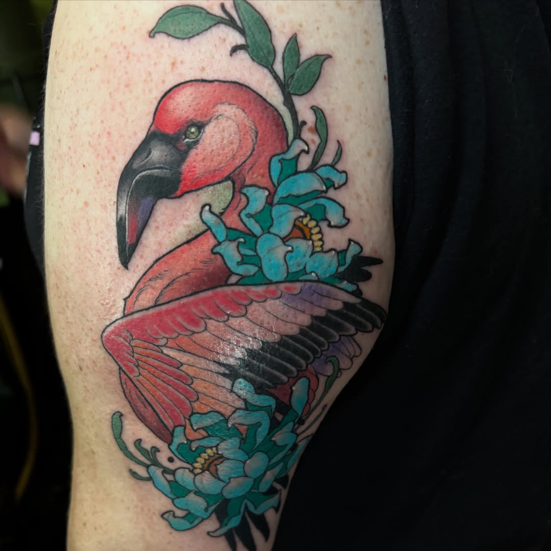 Flamingo and flowers realism tattoo on the upper arm by Alex