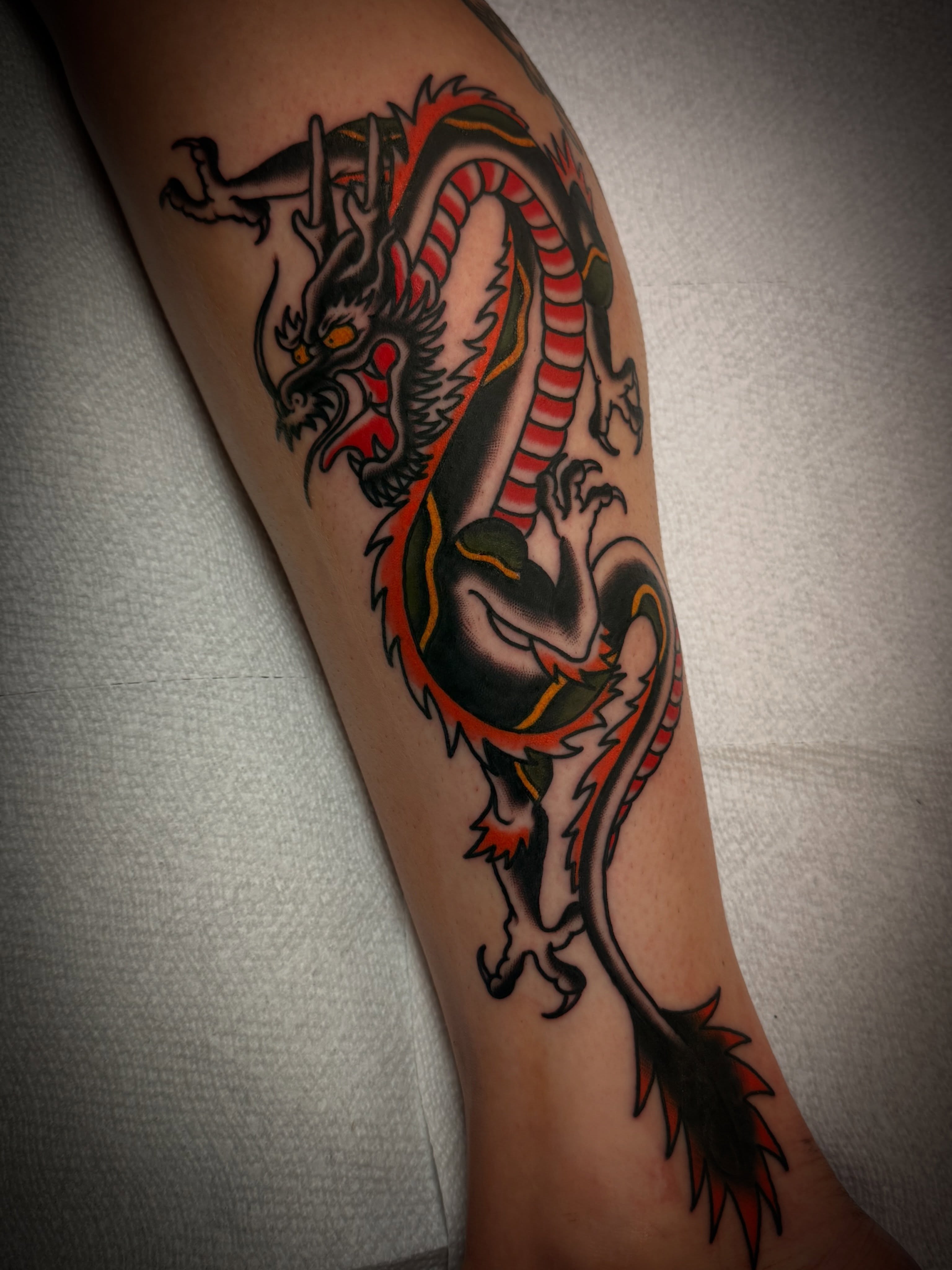 Dragon American traditional tattoo on the forearm by Dave Osrowitz