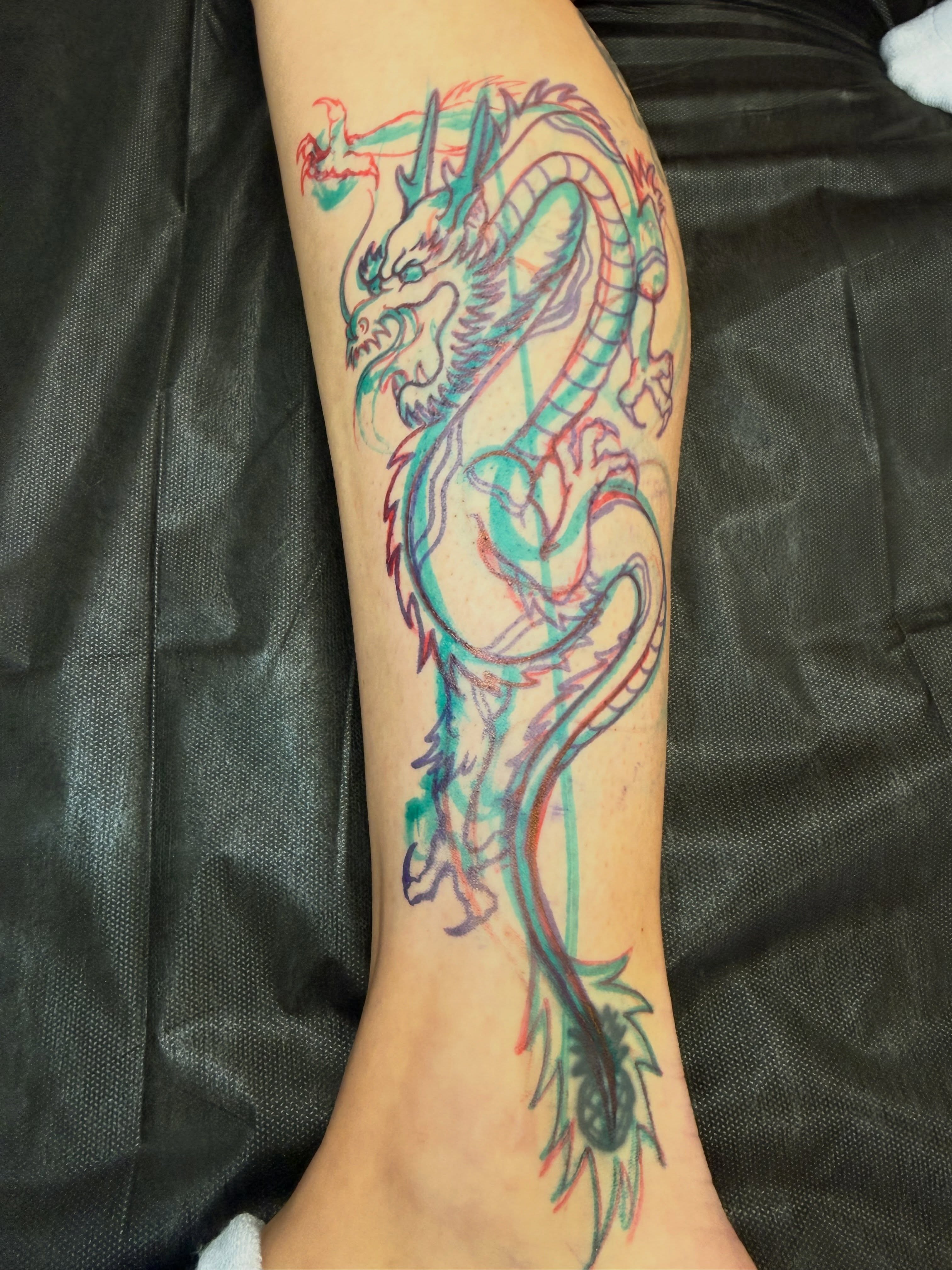 Dragon watercolor tattoo on the forearm by Dave Osrowitz
