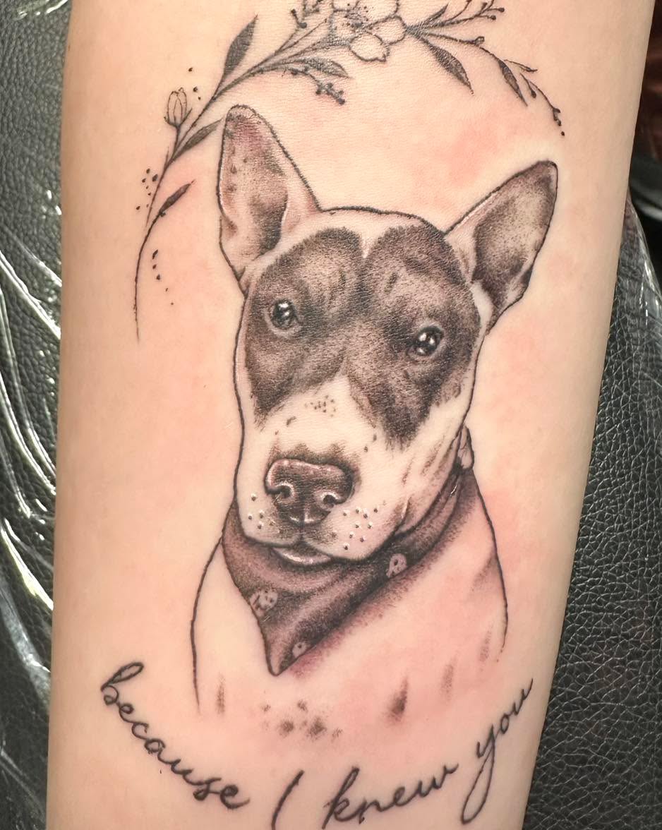 Dog portrait with bandana and text realism tattoo on the forearm by Sarah Nash