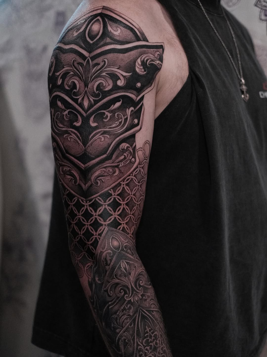 Ornate armor sleeve geometric tattoo on the upper arm by Isabelle Kellar, San Diego, California