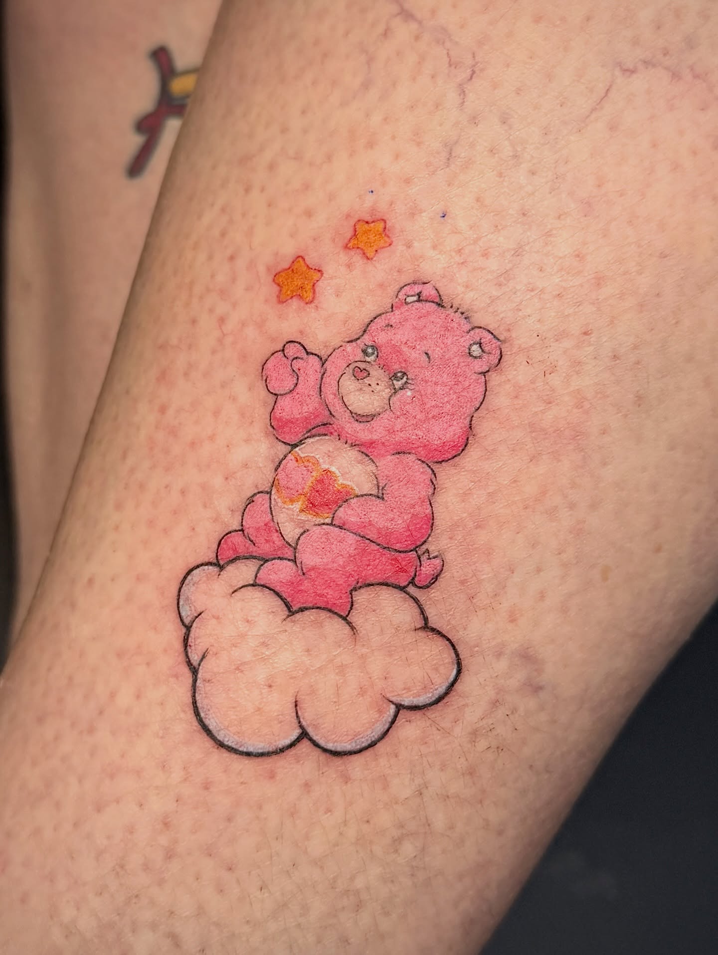 Care bear watercolor tattoo on the forearm by 𝐀𝐝𝐫𝐢𝐞𝐥 𝐓𝐢𝐧𝐤𝐥𝐞𝐧𝐛𝐞𝐫𝐠 ⏾, Denison, Iowa