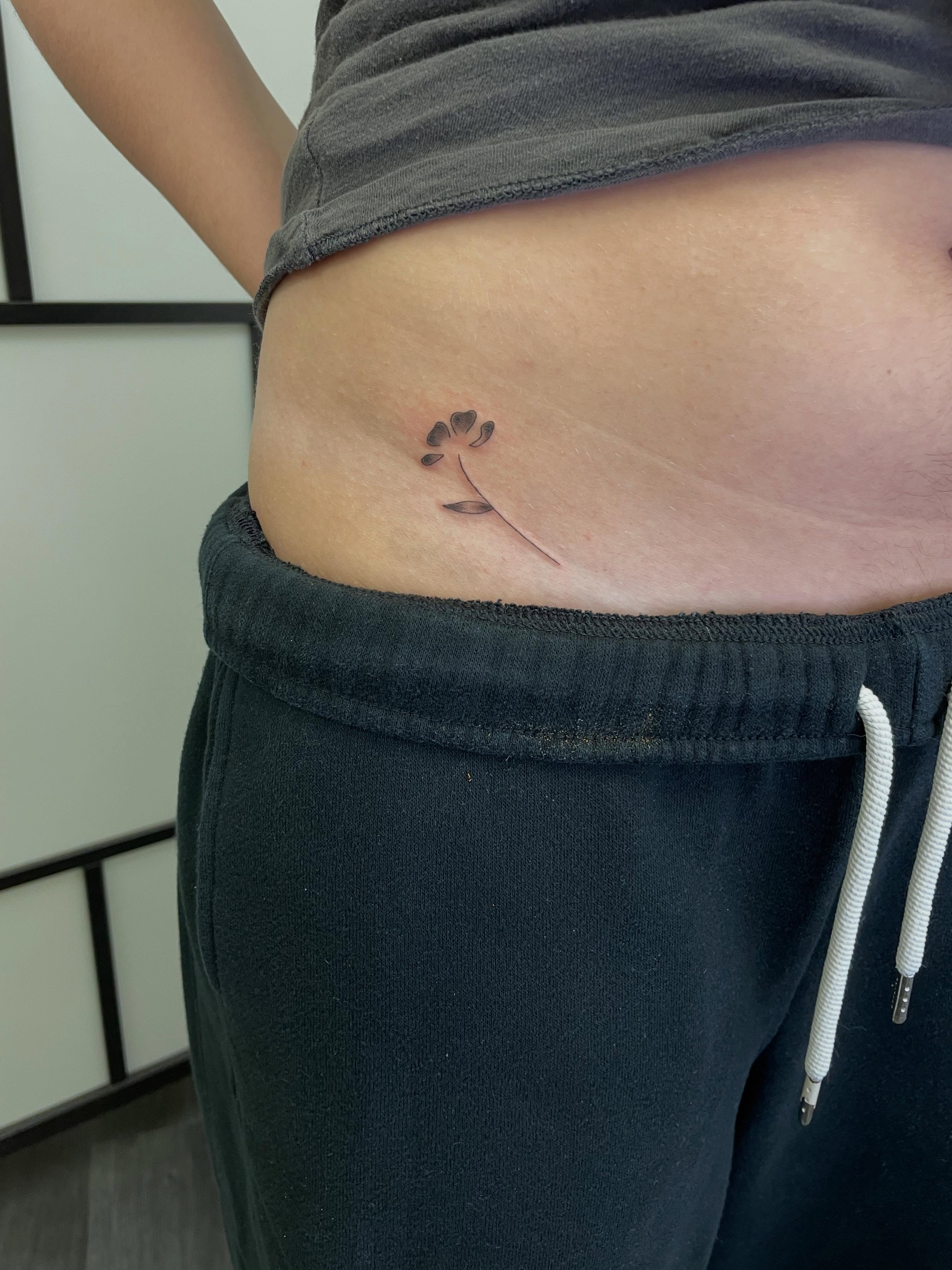 Flower minimalist tattoo by Gel Clark
