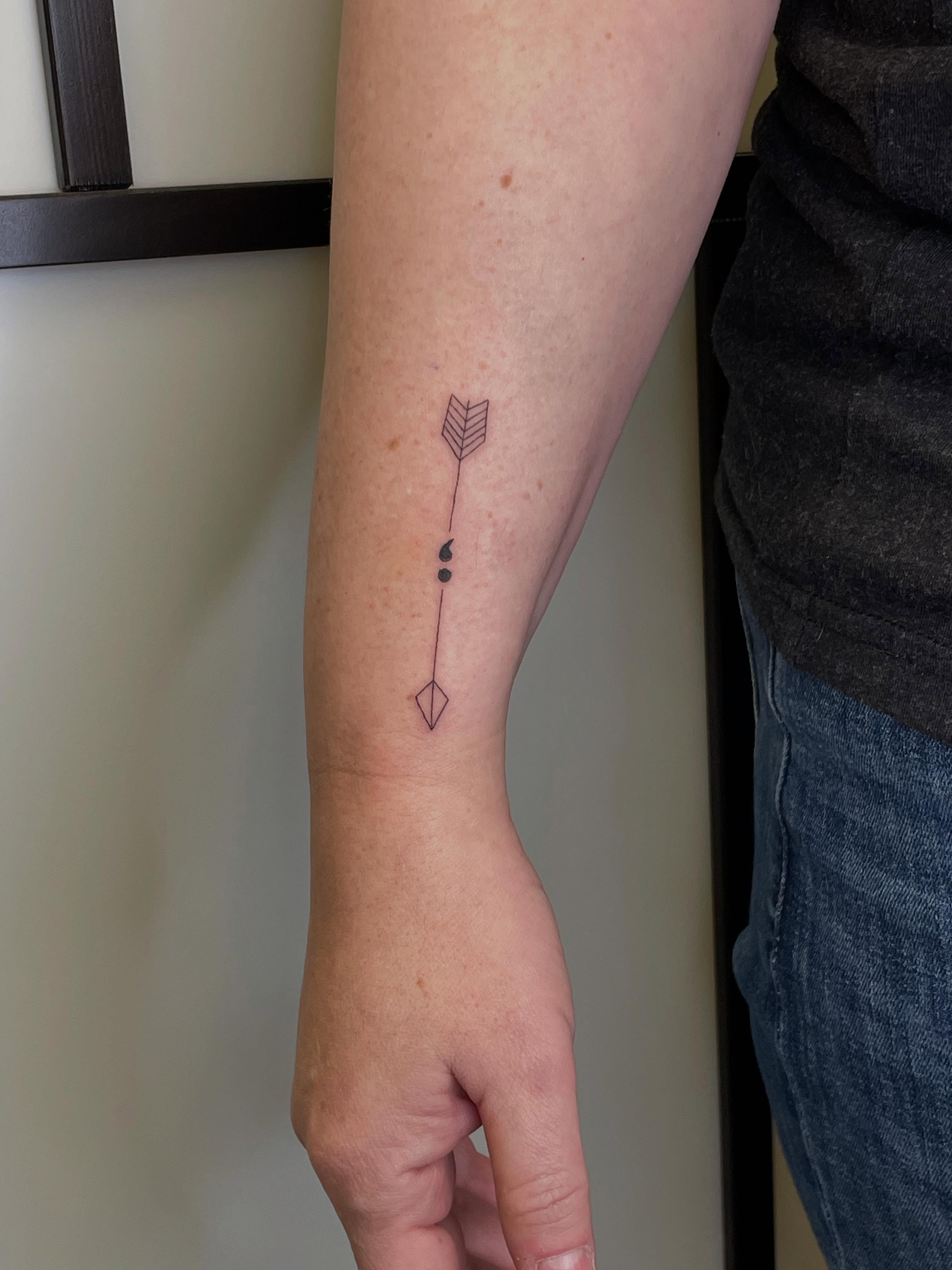 Arrow geometric tattoo on the forearm by Gel Clark