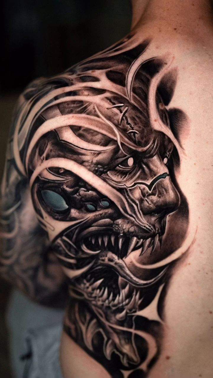 Demonic face realism tattoo on the shoulder by Victor Portugal Tattoo