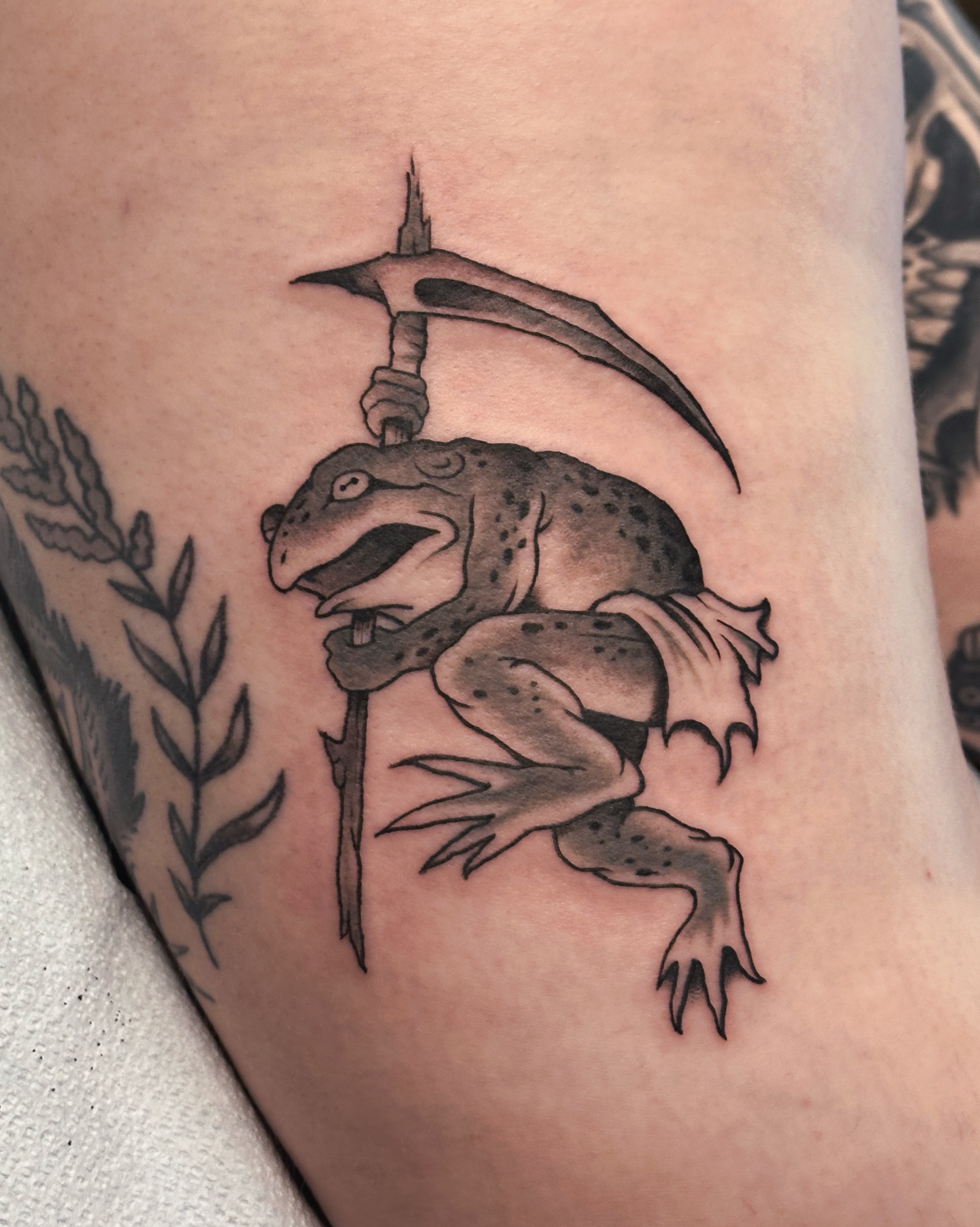 Frog with scythe American traditional tattoo on the thigh by Craig Ryans