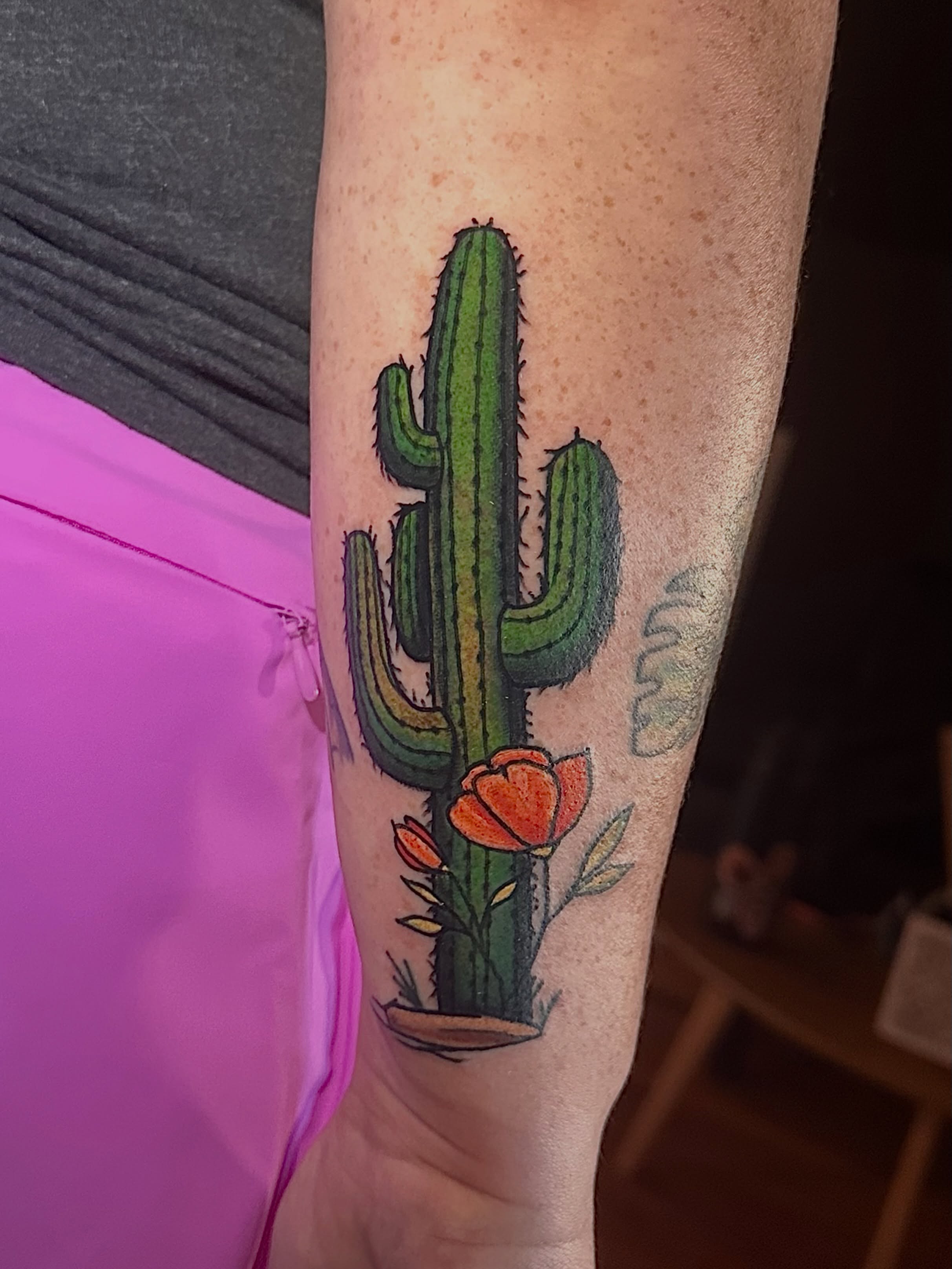 Cactus with flowers realism tattoo on the forearm by Cory Wasmund (blue check)