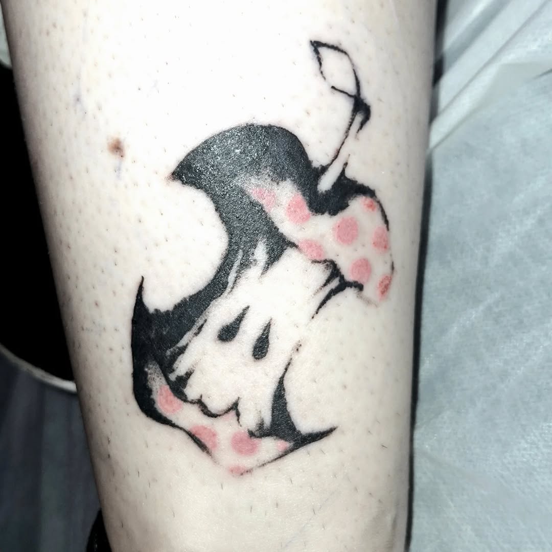Bitten apple with skull face realism tattoo on the forearm by hallowed girl tattoo