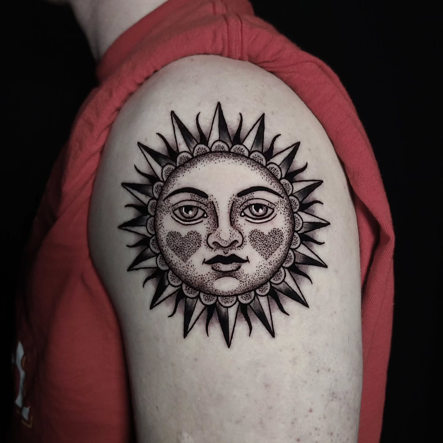 Sun face dotwork tattoo on the shoulder by Alex Stairs