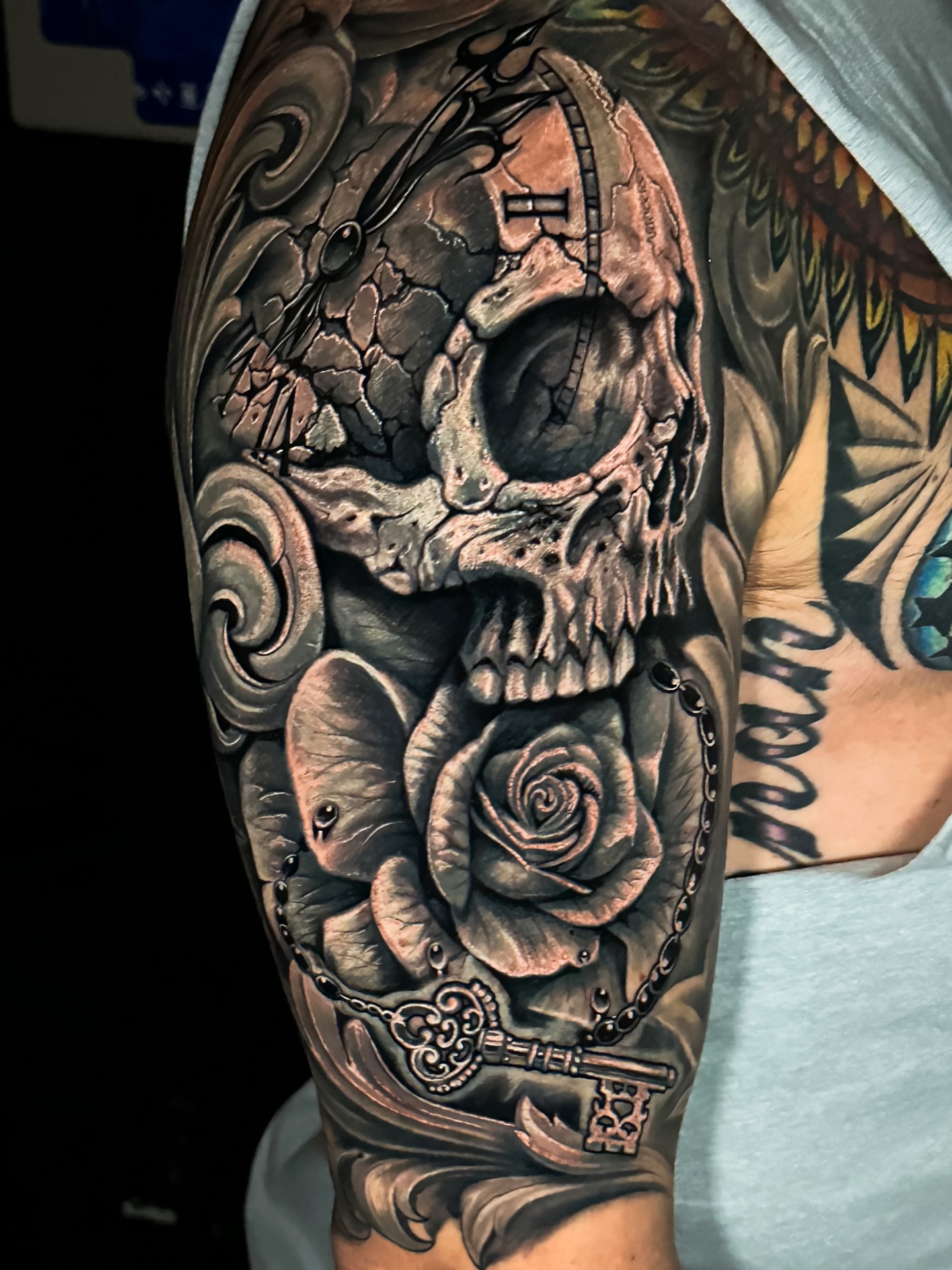 Skull and rose realism tattoo on the forearm by Omar Sheriff Herrera