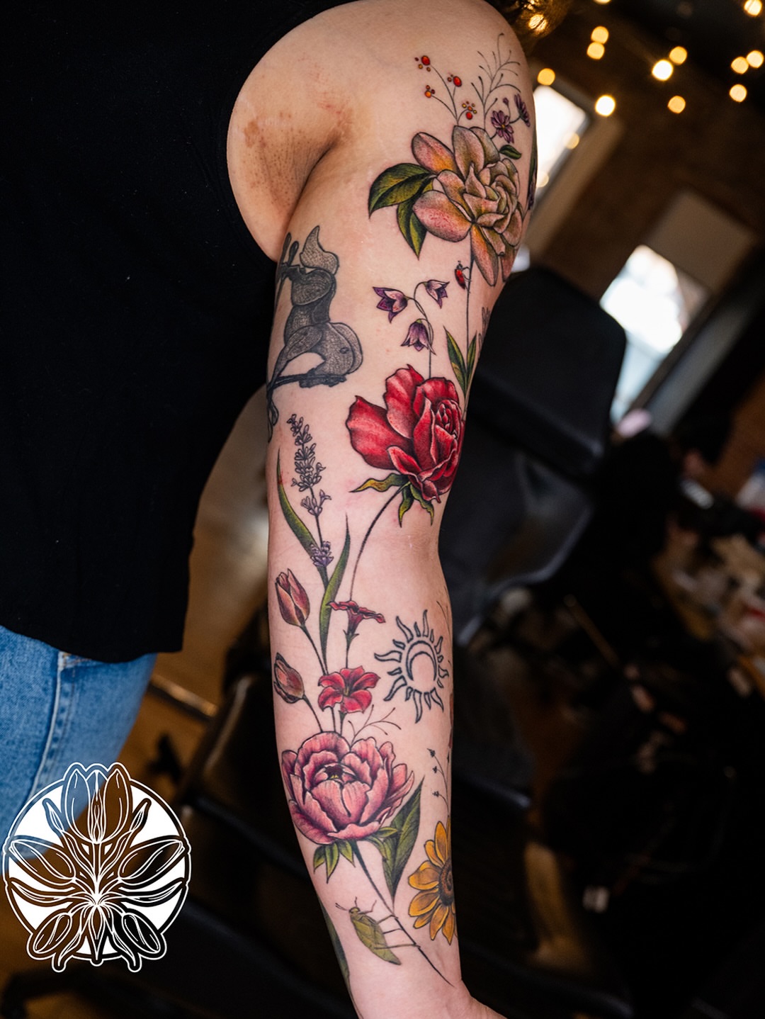 Floral bouquet new school tattoo on the forearm by Ori Merchan Tattoo, Kansas City, Missouri