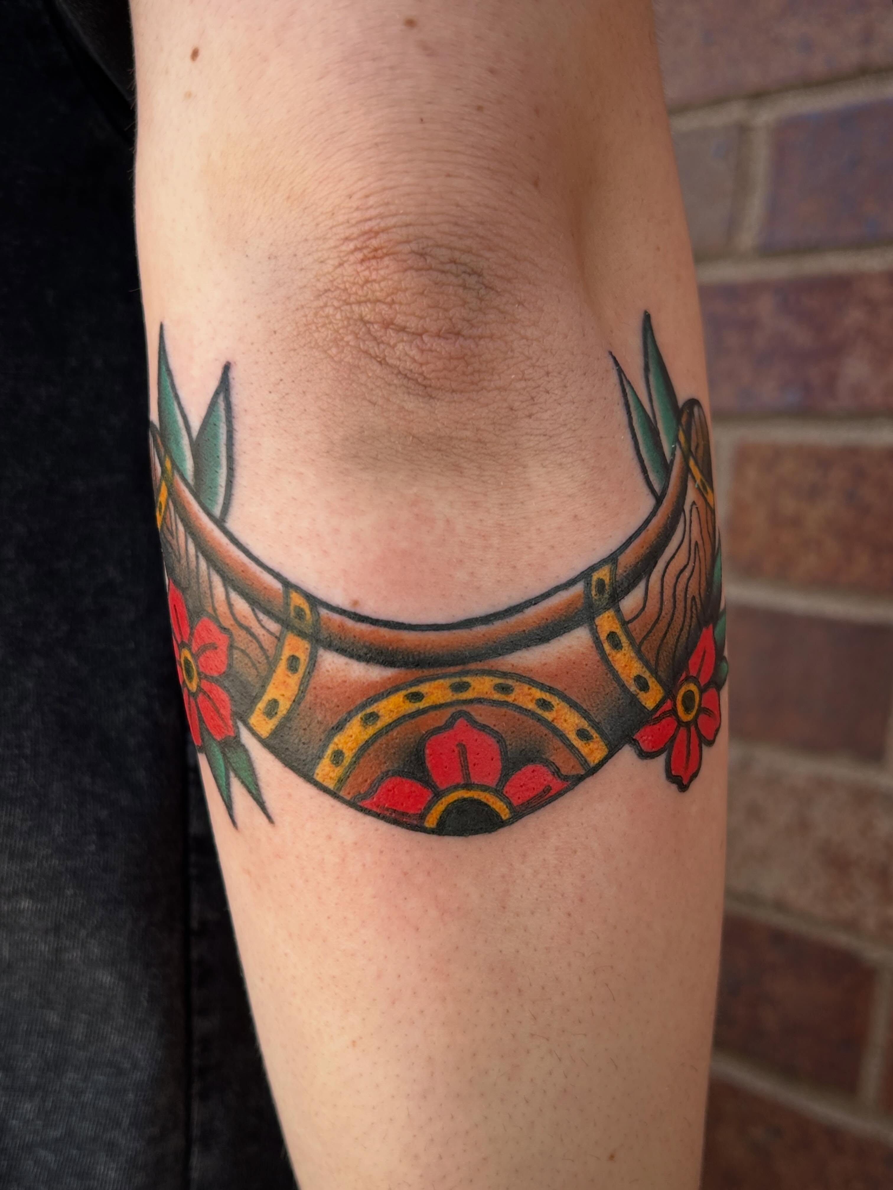 Horseshoe and flowers American traditional tattoo on the forearm by Morgan Hazer Tattoos, Cedar Rapids, Iowa