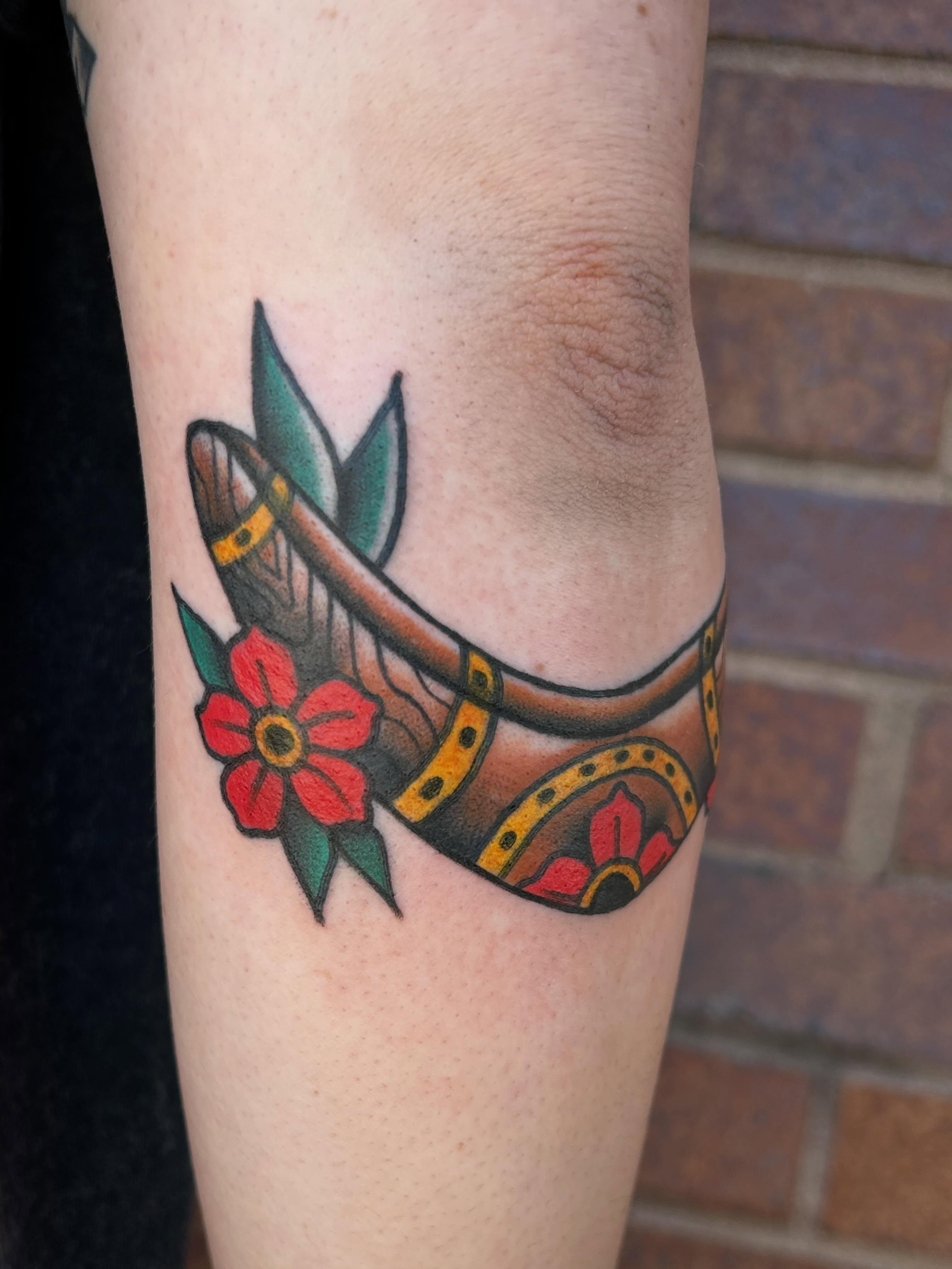 Horseshoe and flower American traditional tattoo on the forearm by Morgan Hazer Tattoos, Cedar Rapids, Iowa
