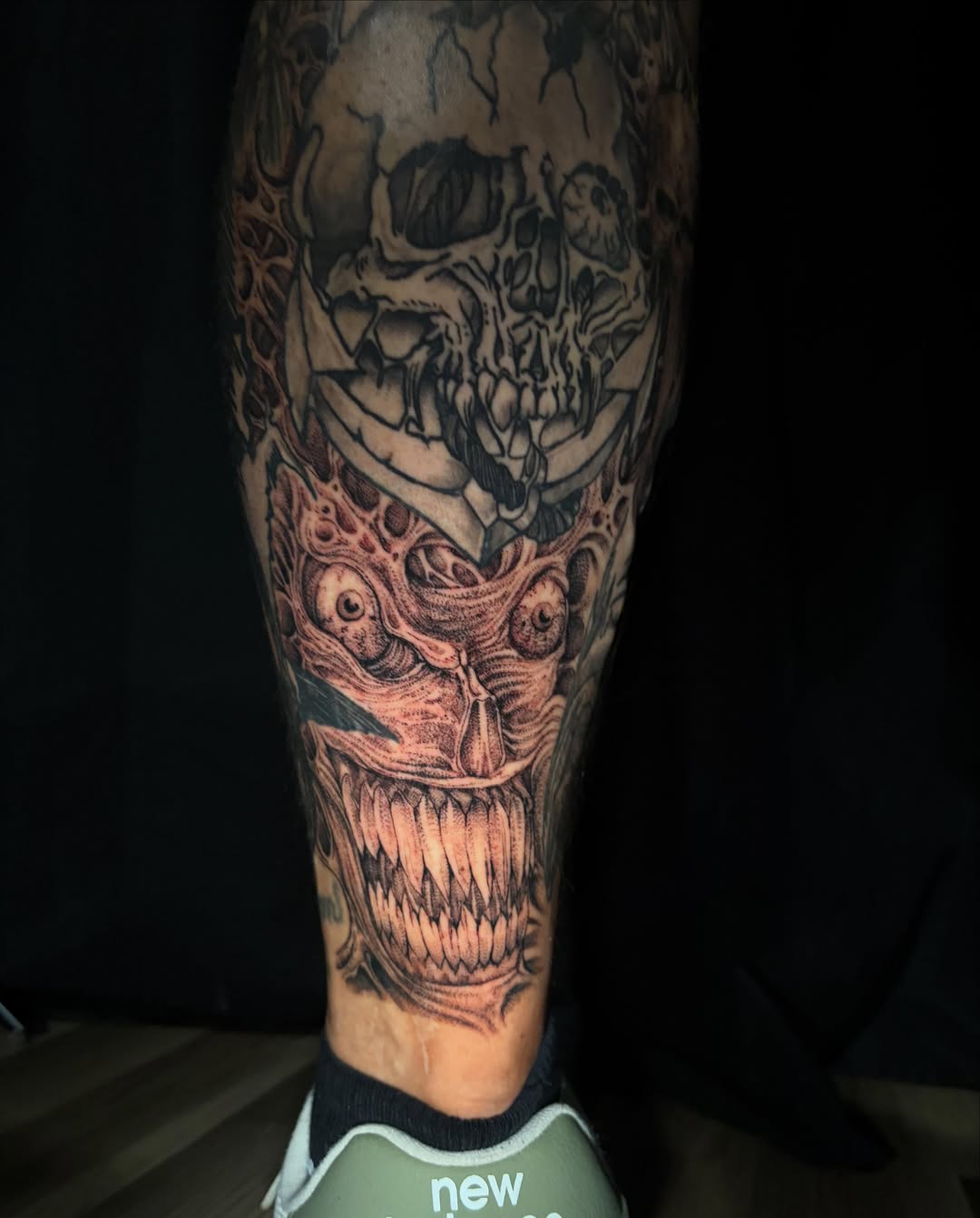 Skull and demon dark realism tattoo on the calf by Crawlspacecadet