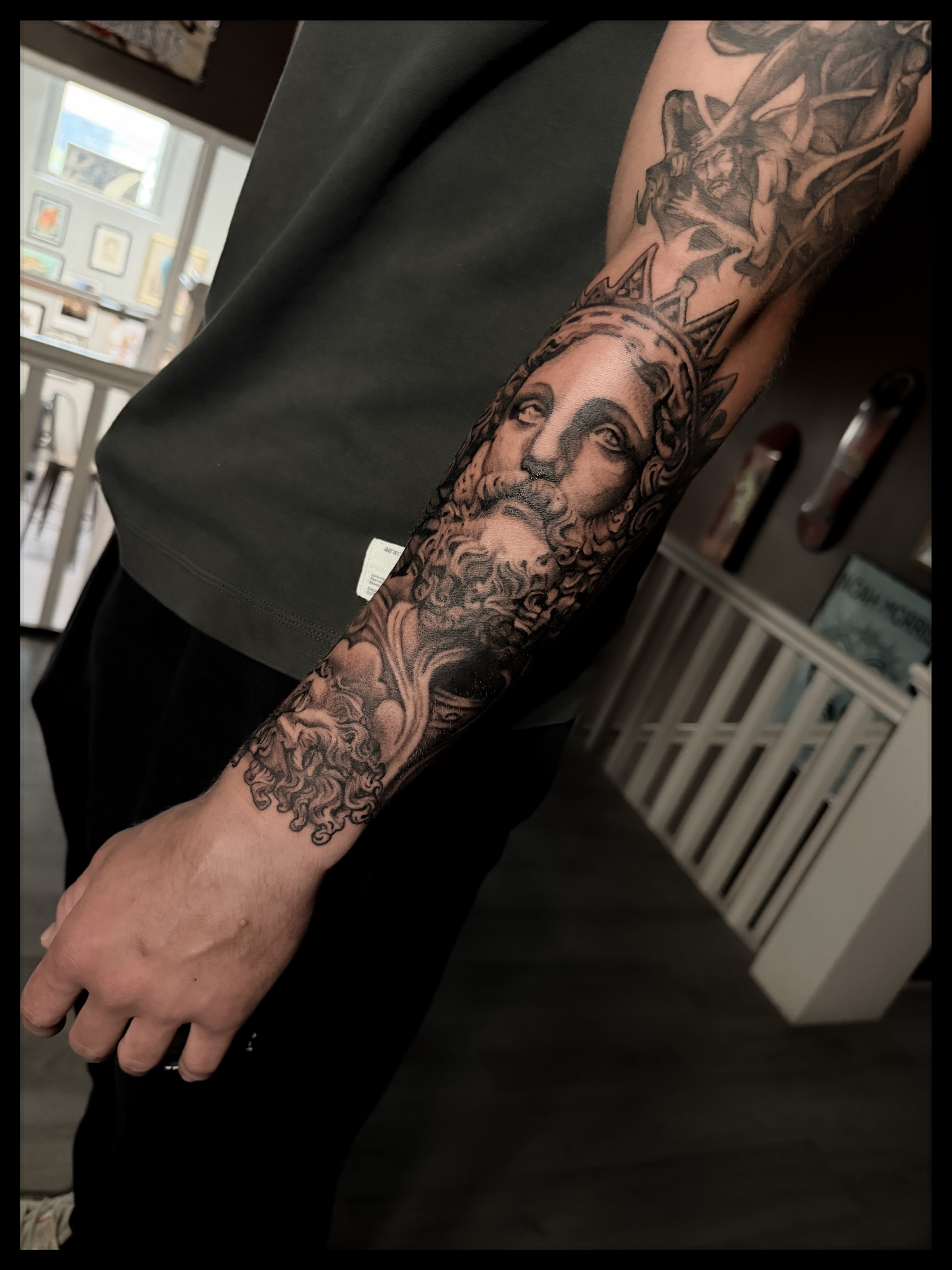 Bearded man with crown realism tattoo on the forearm by Noah Morris