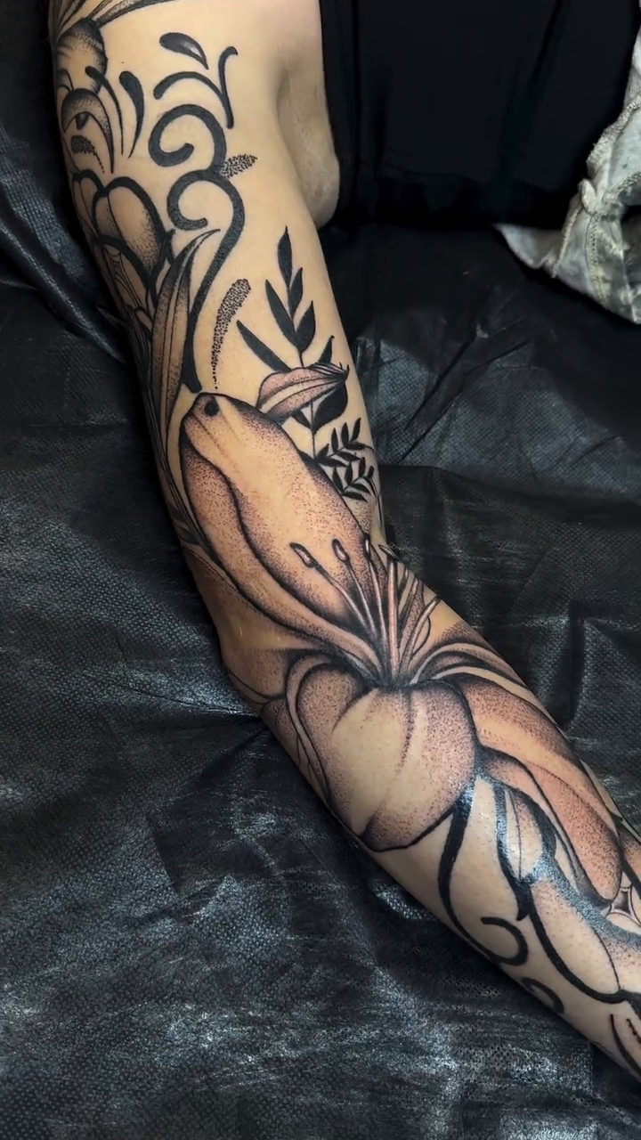 Lily and ornamental swirls on arm fine line tattoo on the forearm by Ciera Farni, Murray, Utah