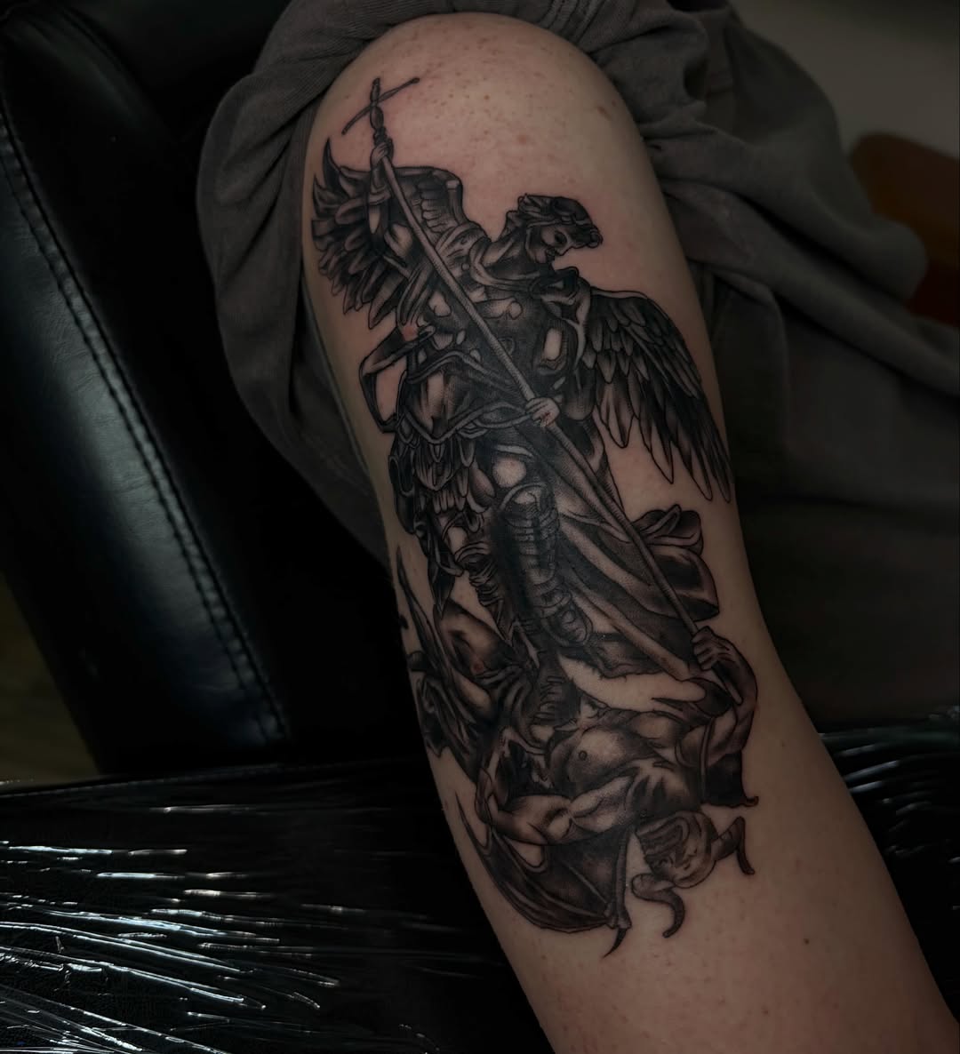 St. michael slaying dragon realism tattoo on the thigh by Cincinnati Tattoo Artist