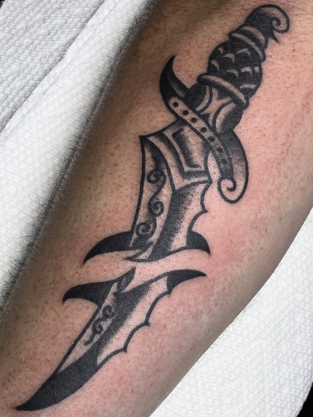 Ornamental dagger tribal tattoo on the forearm by Sav Robinson