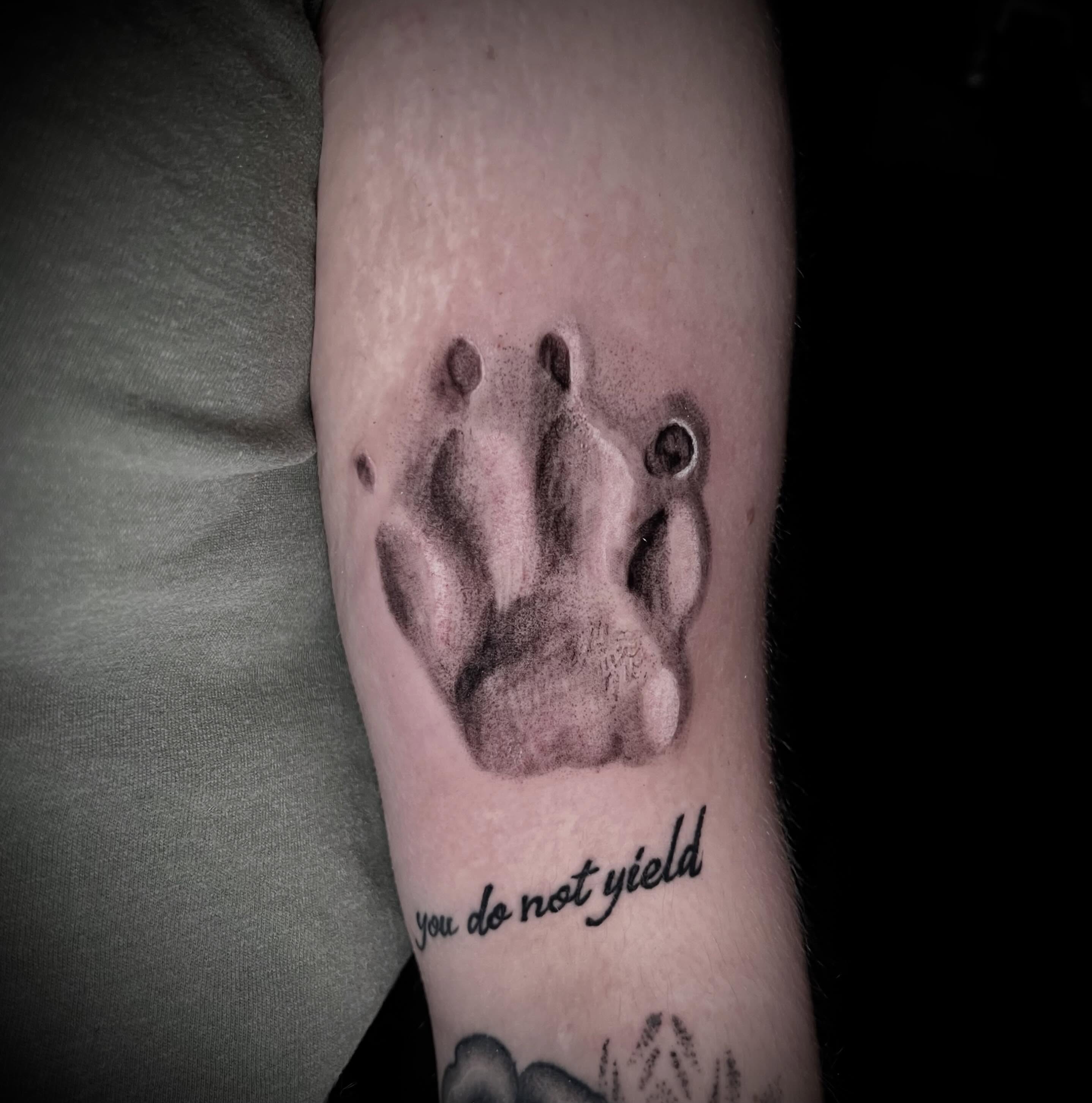 Bear paw print dotwork tattoo on the forearm by James Richardson