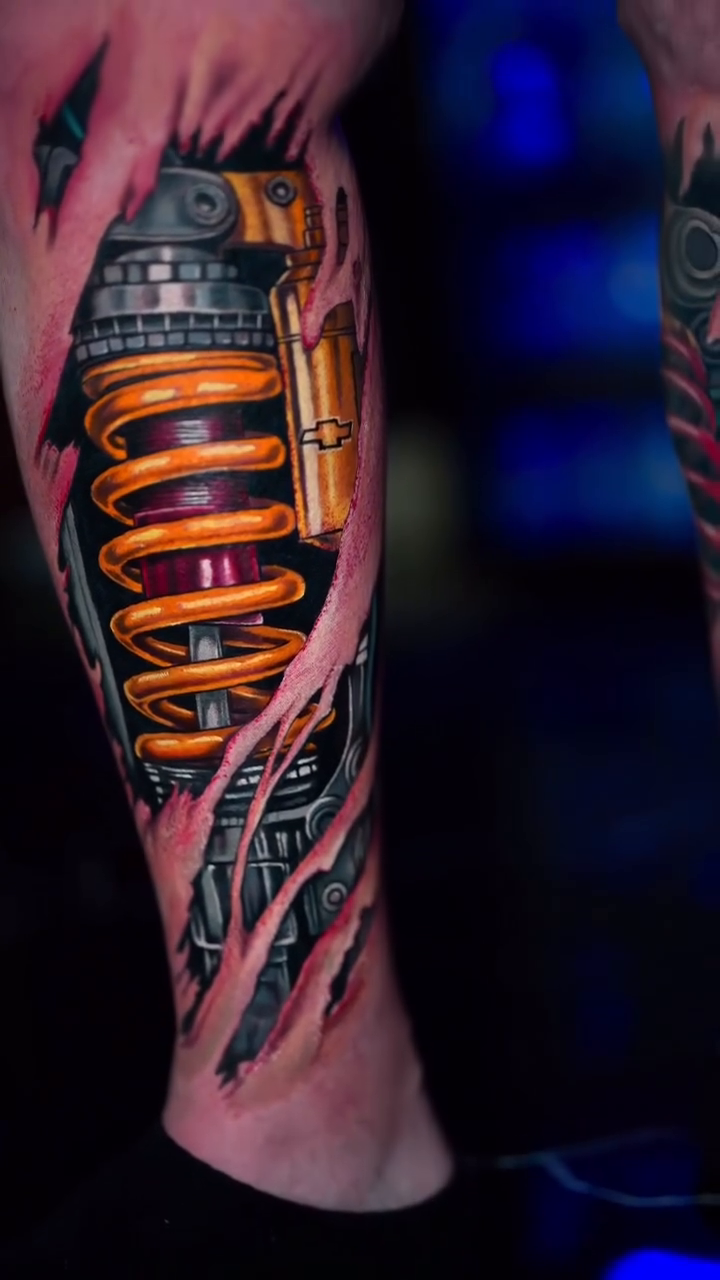 Mechanical shock absorber tattoo biomech tattoo on the forearm by Yasmani ramirez