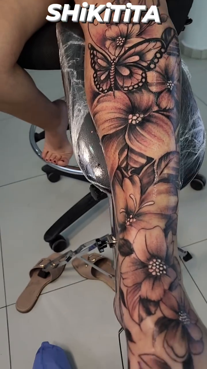 Butterfly and flowers realism tattoo by Aguascali Firme