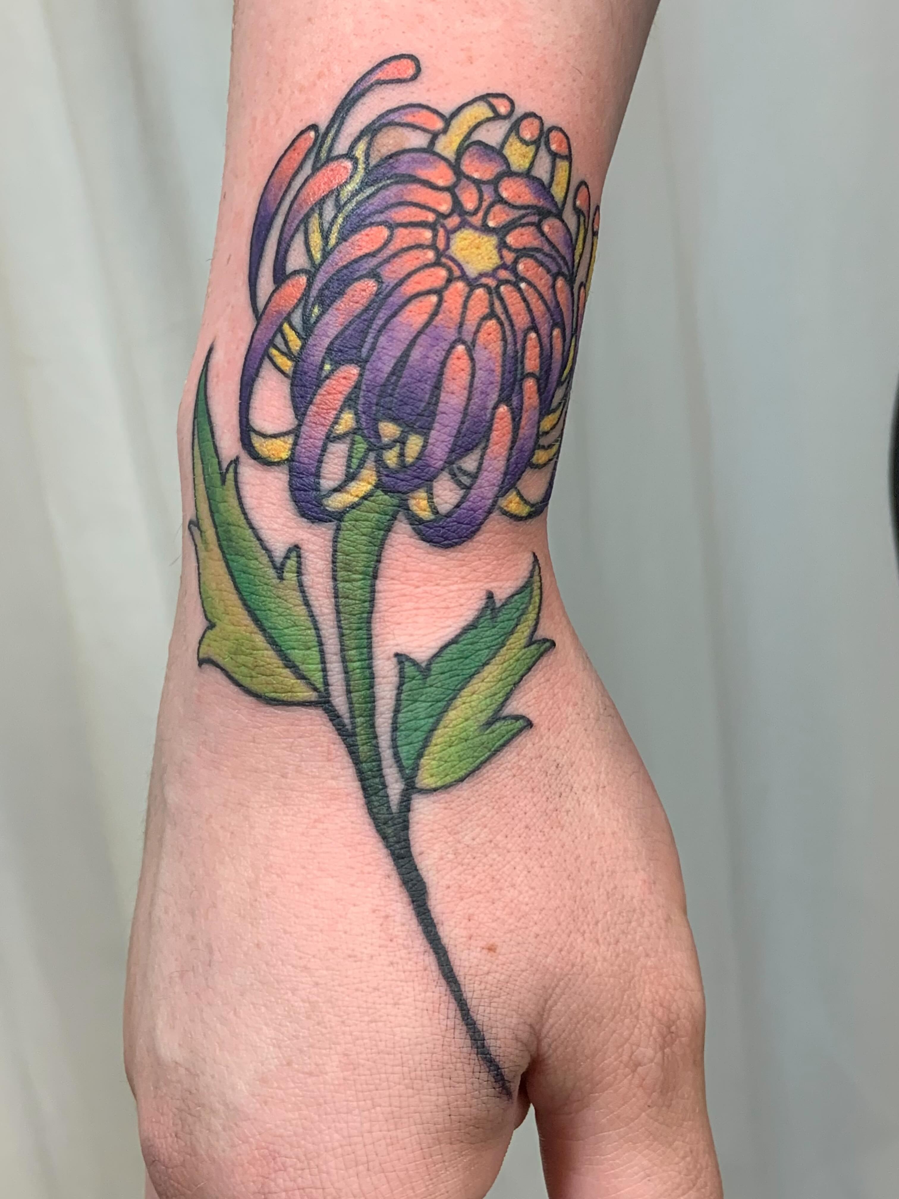 Chrysanthemum new school tattoo on the forearm by Tattoos By Court