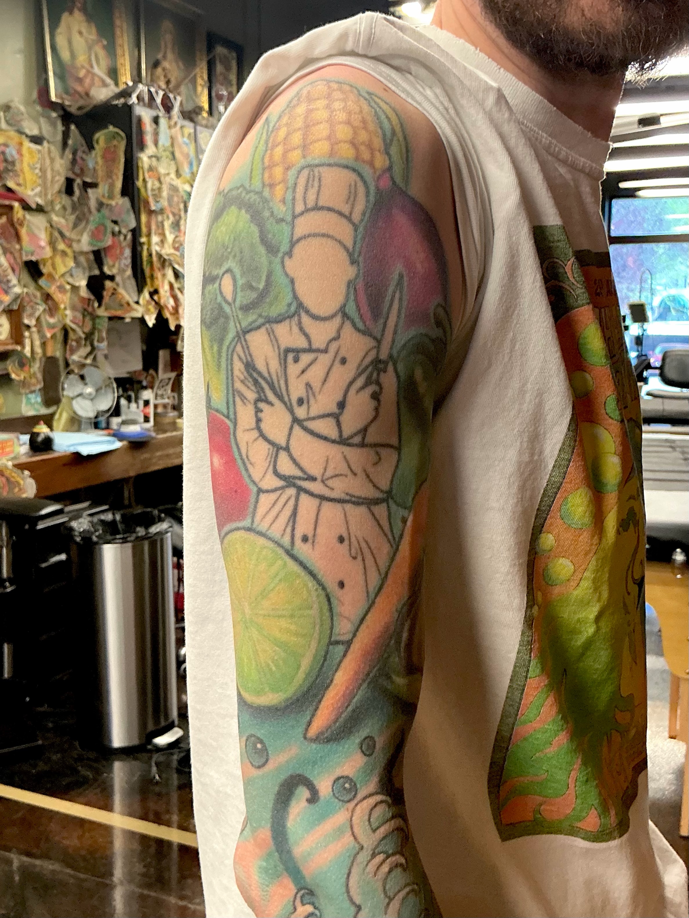 Chef with fruits new school tattoo on the upper arm by JoshUA Bowers, Des Moines, Iowa