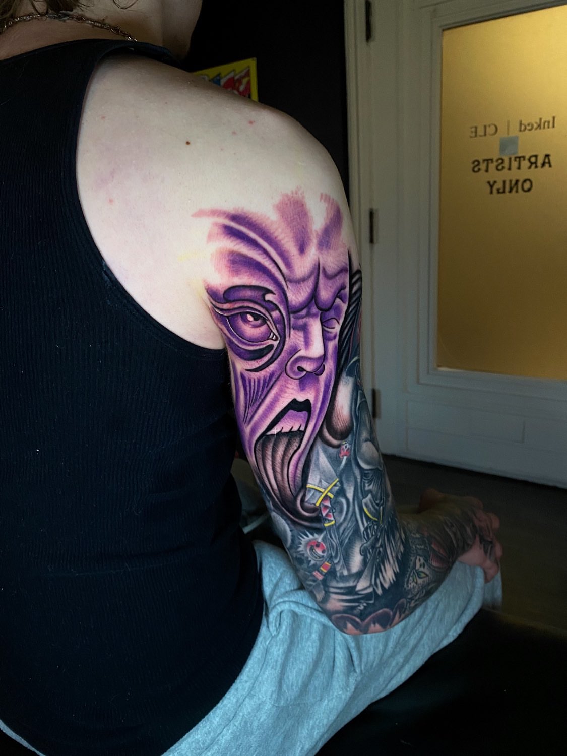 Demon face dark realism tattoo on the upper arm by Kelan Mckenna