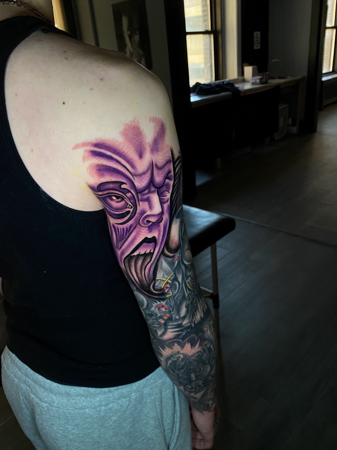 Demon face dark realism tattoo on the upper arm by Kelan Mckenna