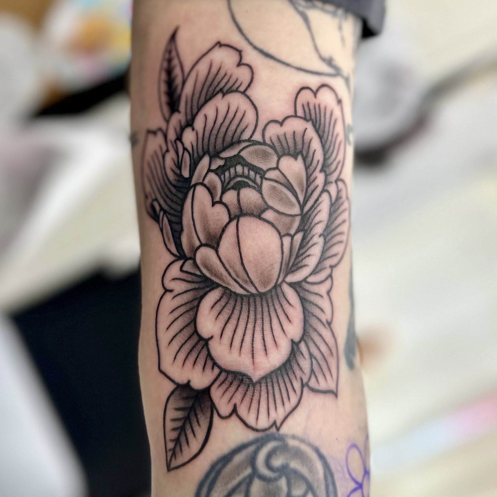 Peony black and grey tattoo on the forearm by Jon Anderson