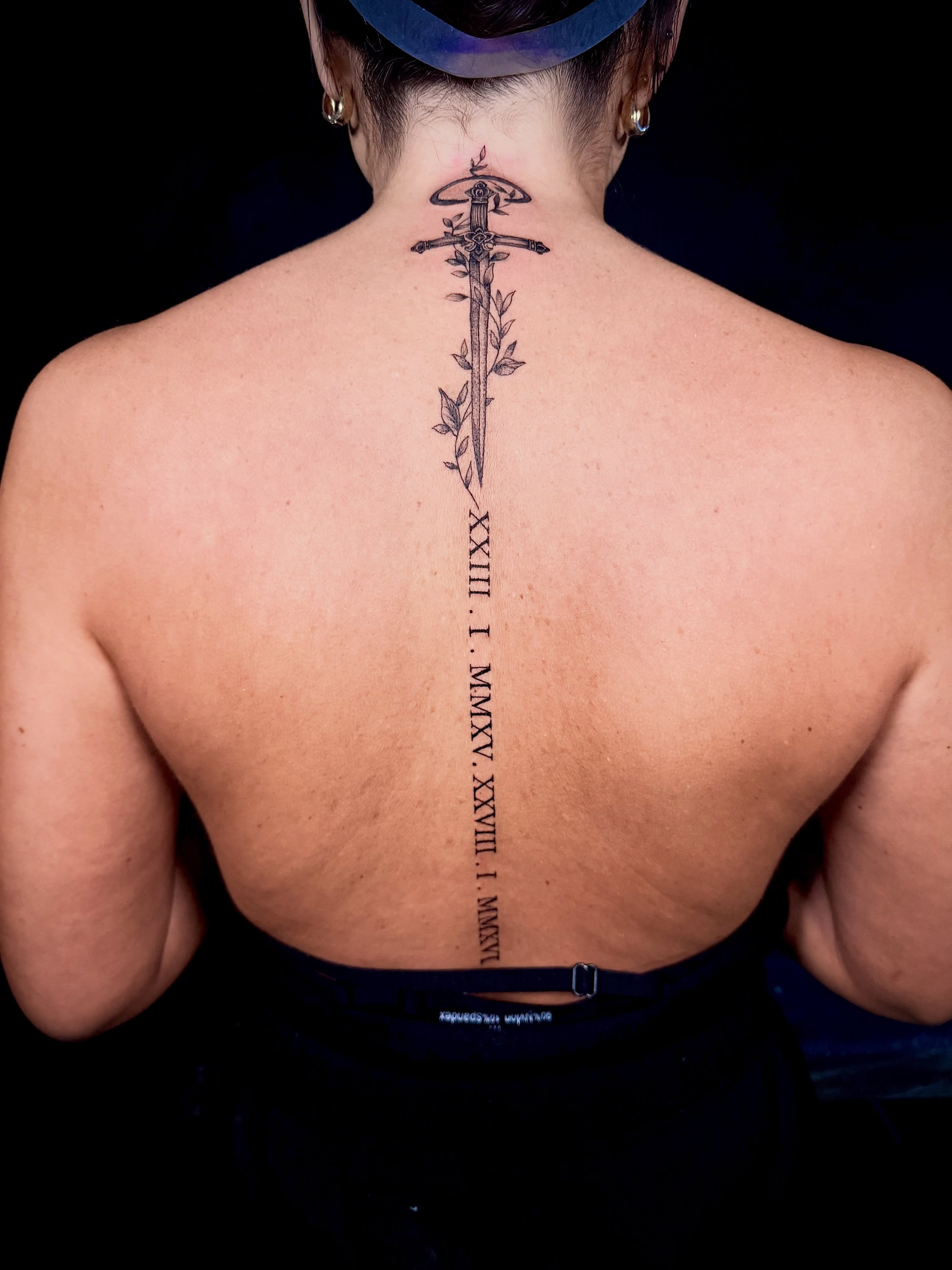 Sword and leaves black and grey tattoo on the back by John Ayson, Murrieta, California