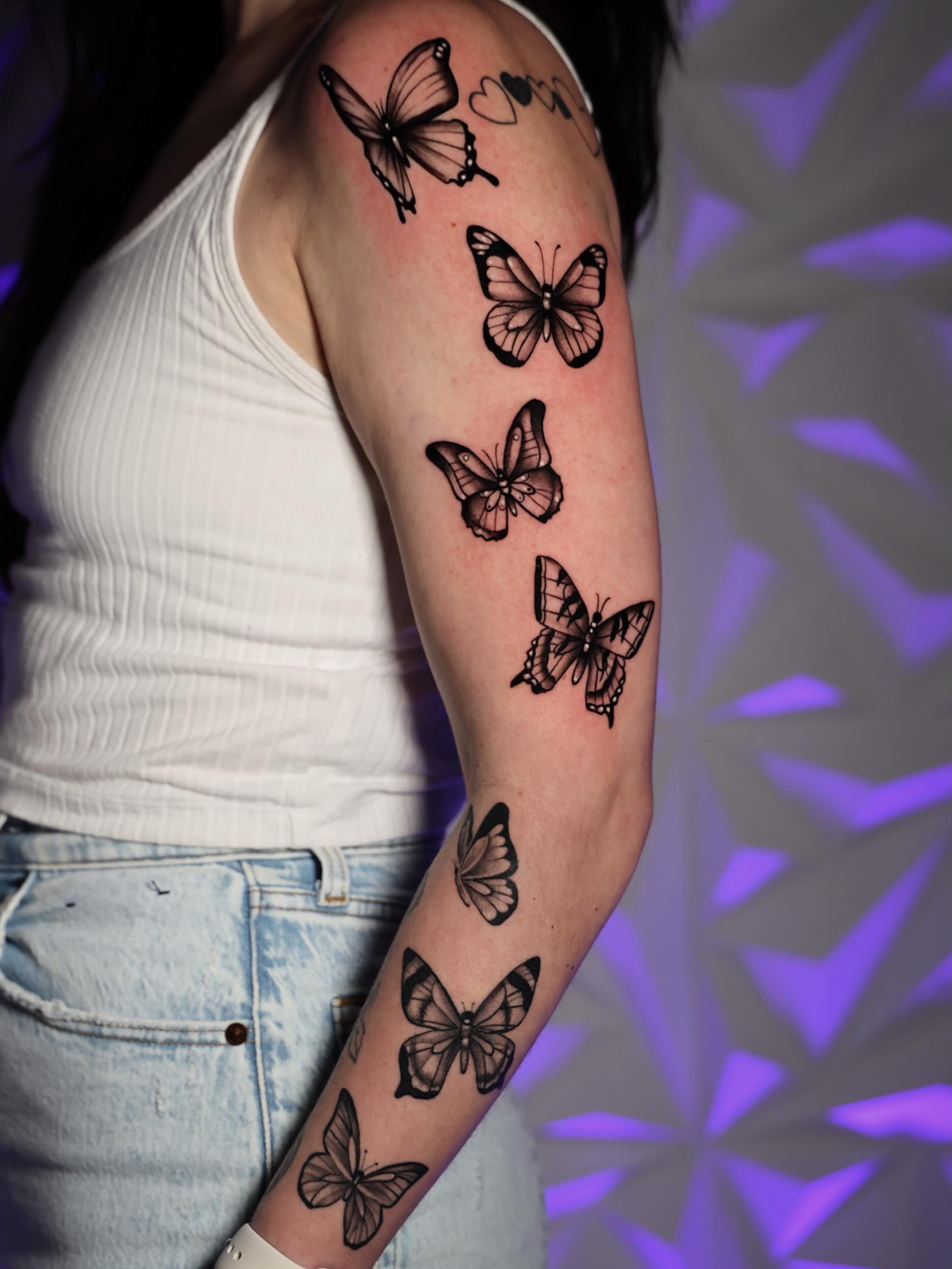 Butterflies black and grey tattoo on the forearm by Haleigh Cunningham, Charlotte, North Carolina