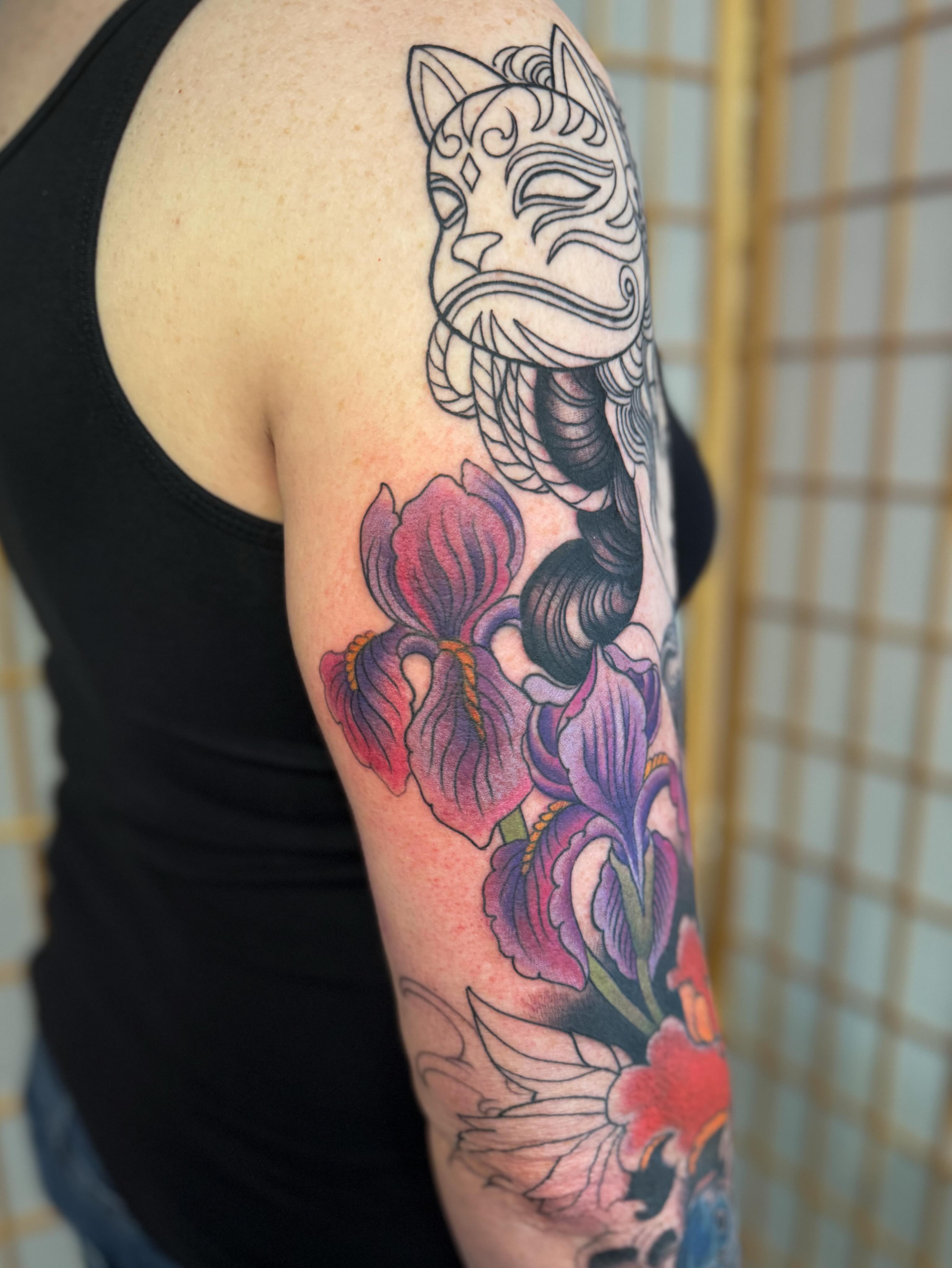 Iris flowers and mask japanese irezumi tattoo on the upper arm by ⚔️ 𝕬𝖓𝖞𝖆 𝖁𝖎𝖈𝖙𝖔𝖗𝖎𝖆 ⚔️, Fairfax, Virginia