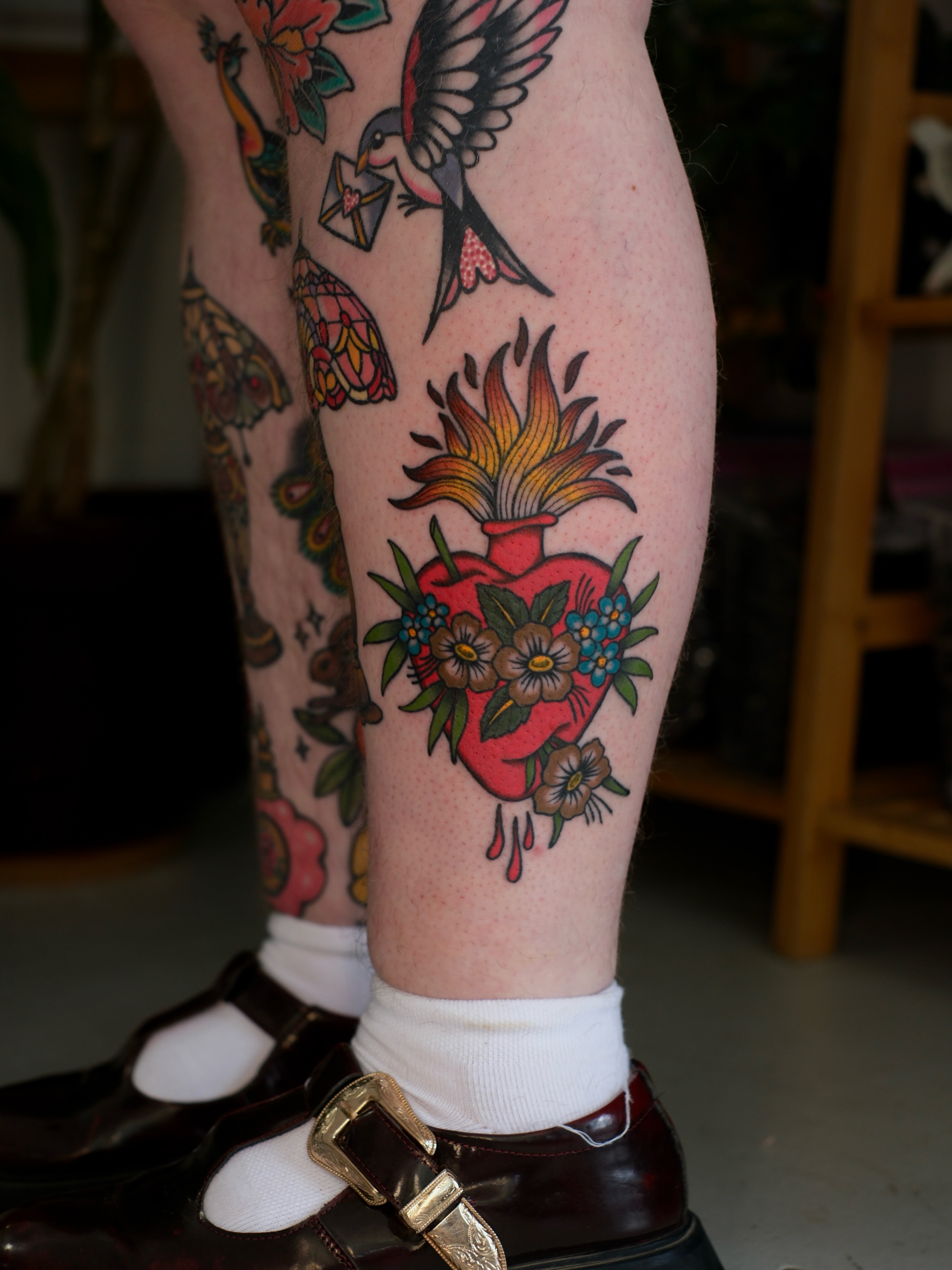 Heart with flowers American traditional tattoo on the leg by Mallory Murphy, Denton, Texas