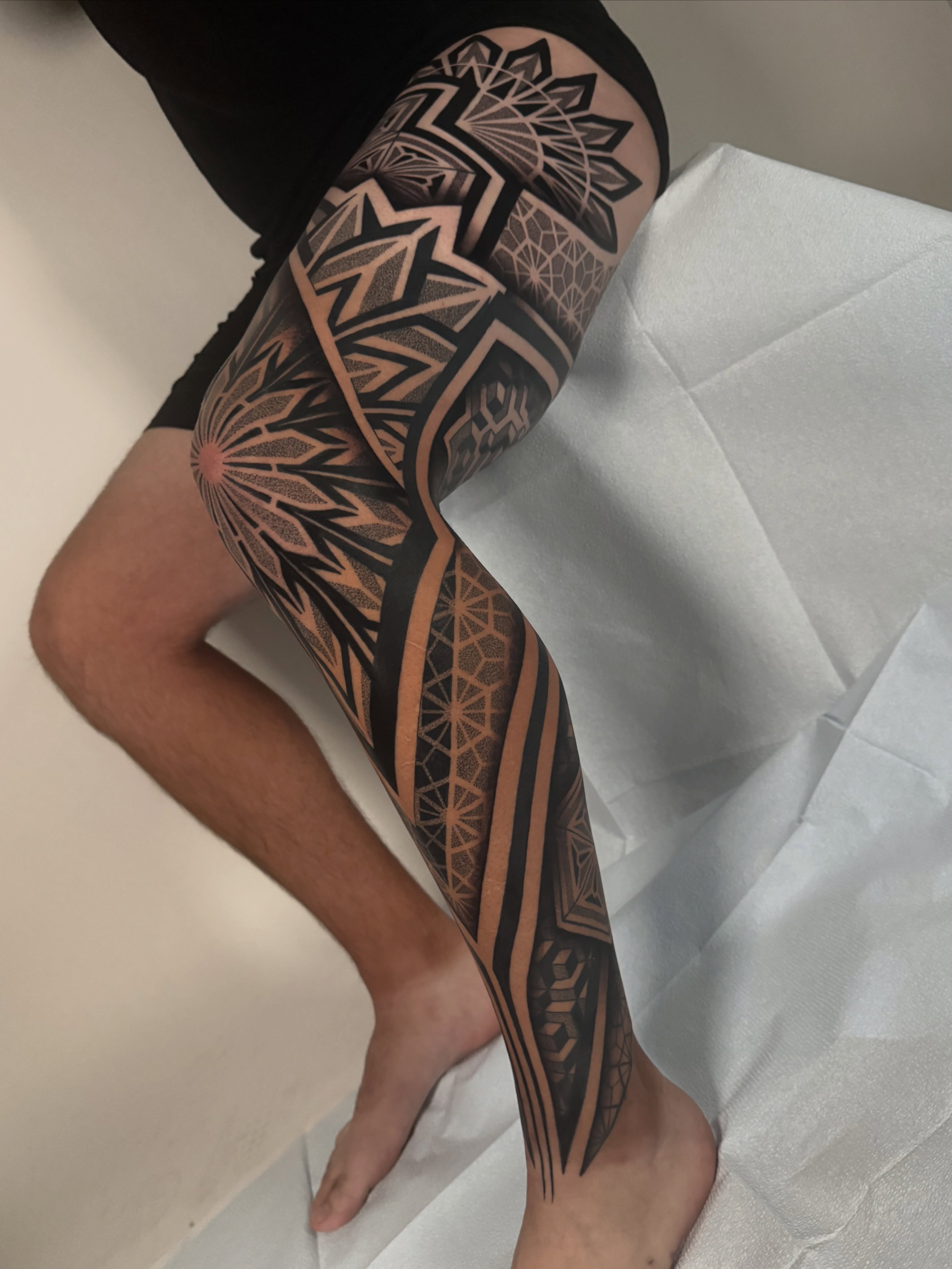 Geometric patterns geometric tattoo on the calf by Mitch Koch