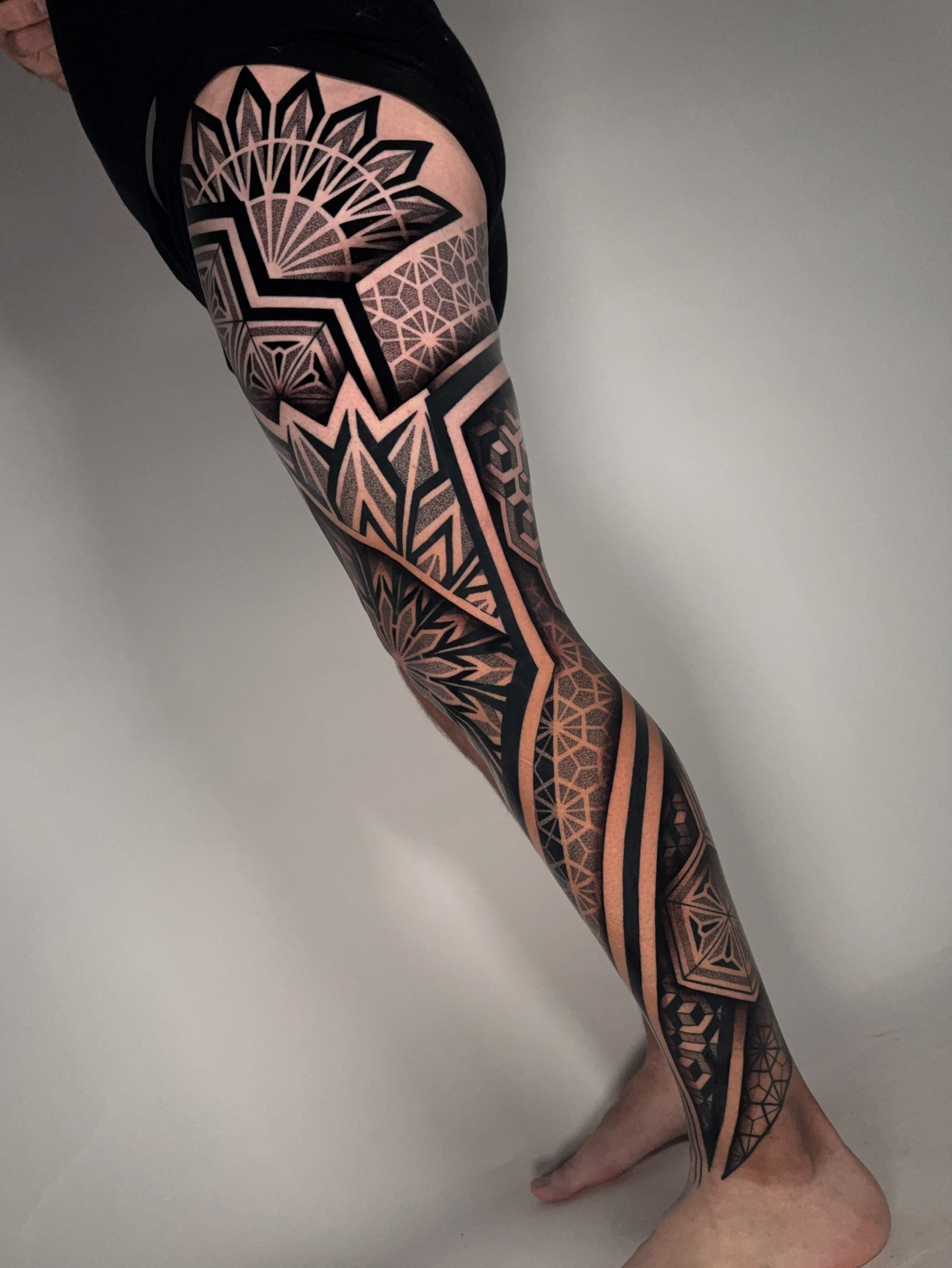 Geometric patterns geometric tattoo on the leg by Mitch Koch