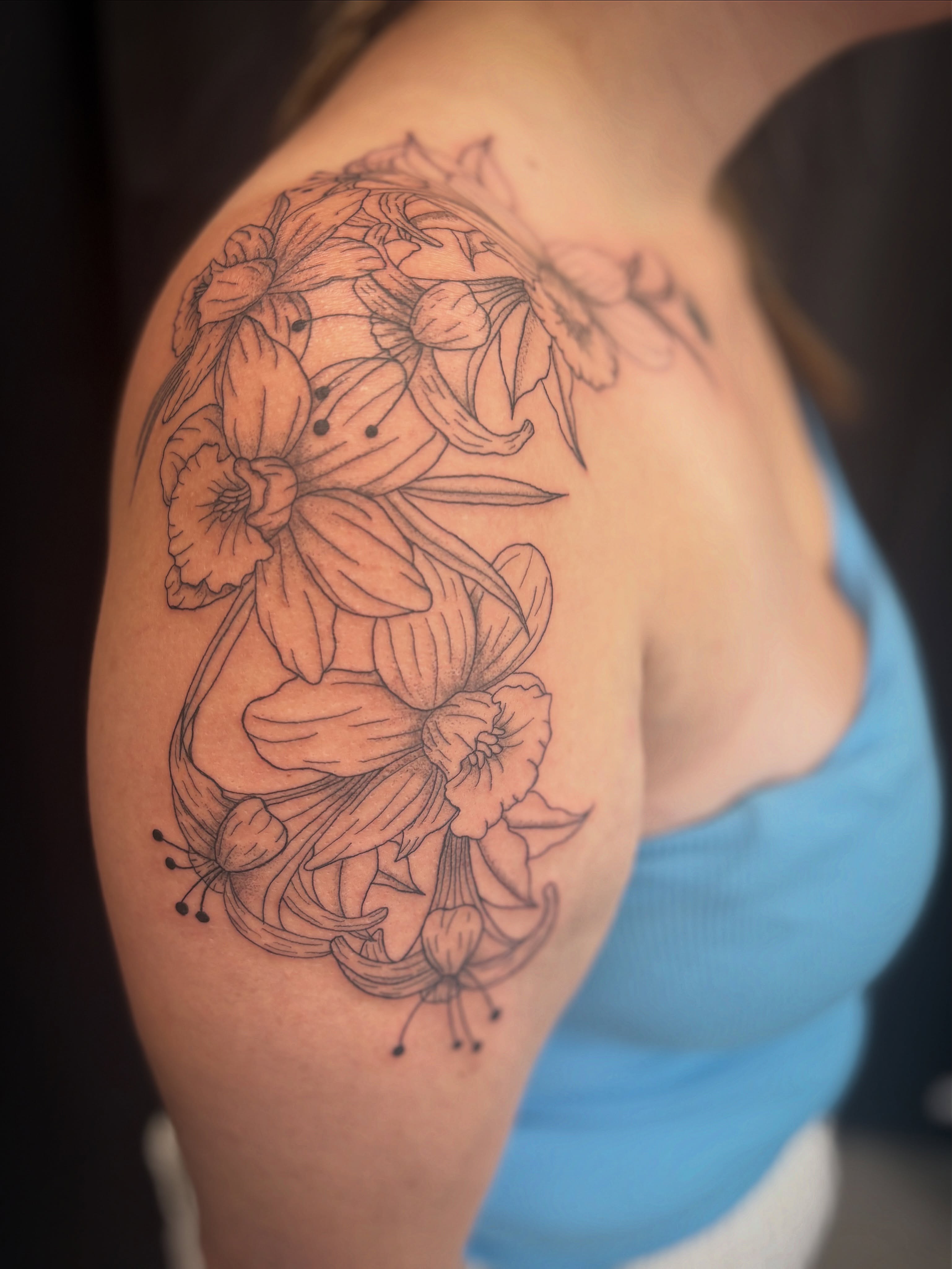 Floral arrangement black and grey tattoo on the shoulder by Holly