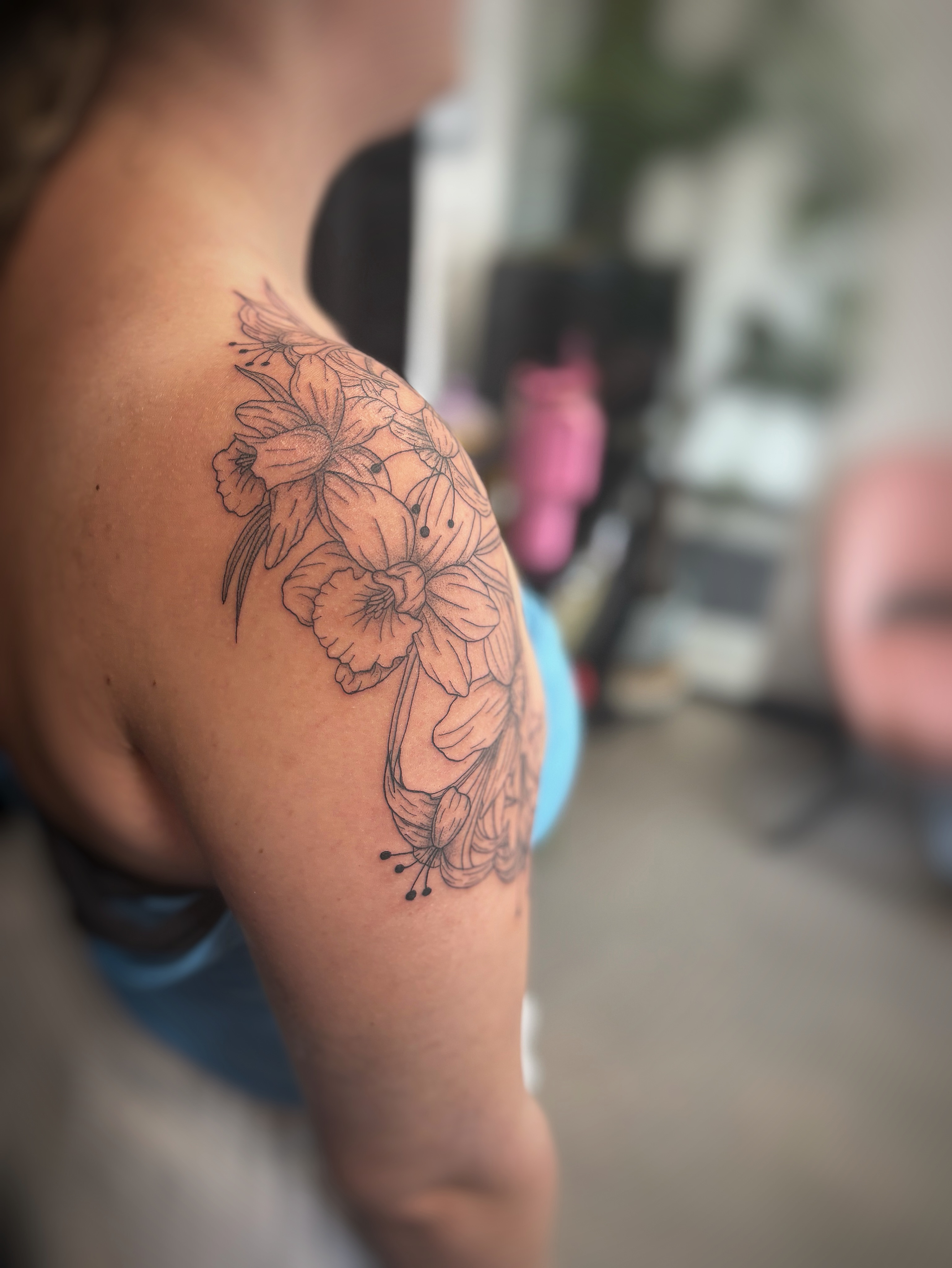 Floral arrangement black and grey tattoo on the shoulder by Holly