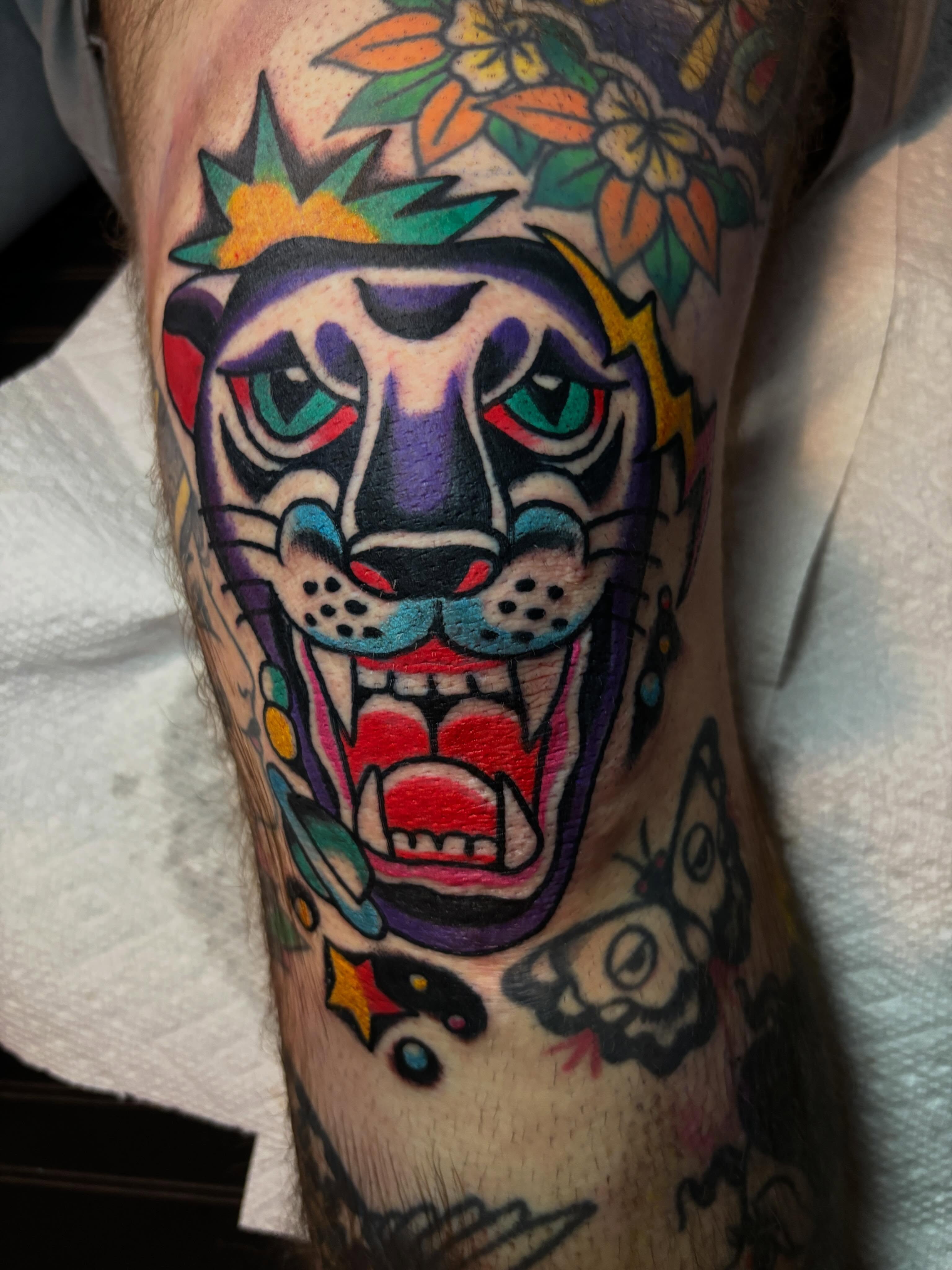 Roaring panther American traditional tattoo on the forearm by Mitch Ashpaugh