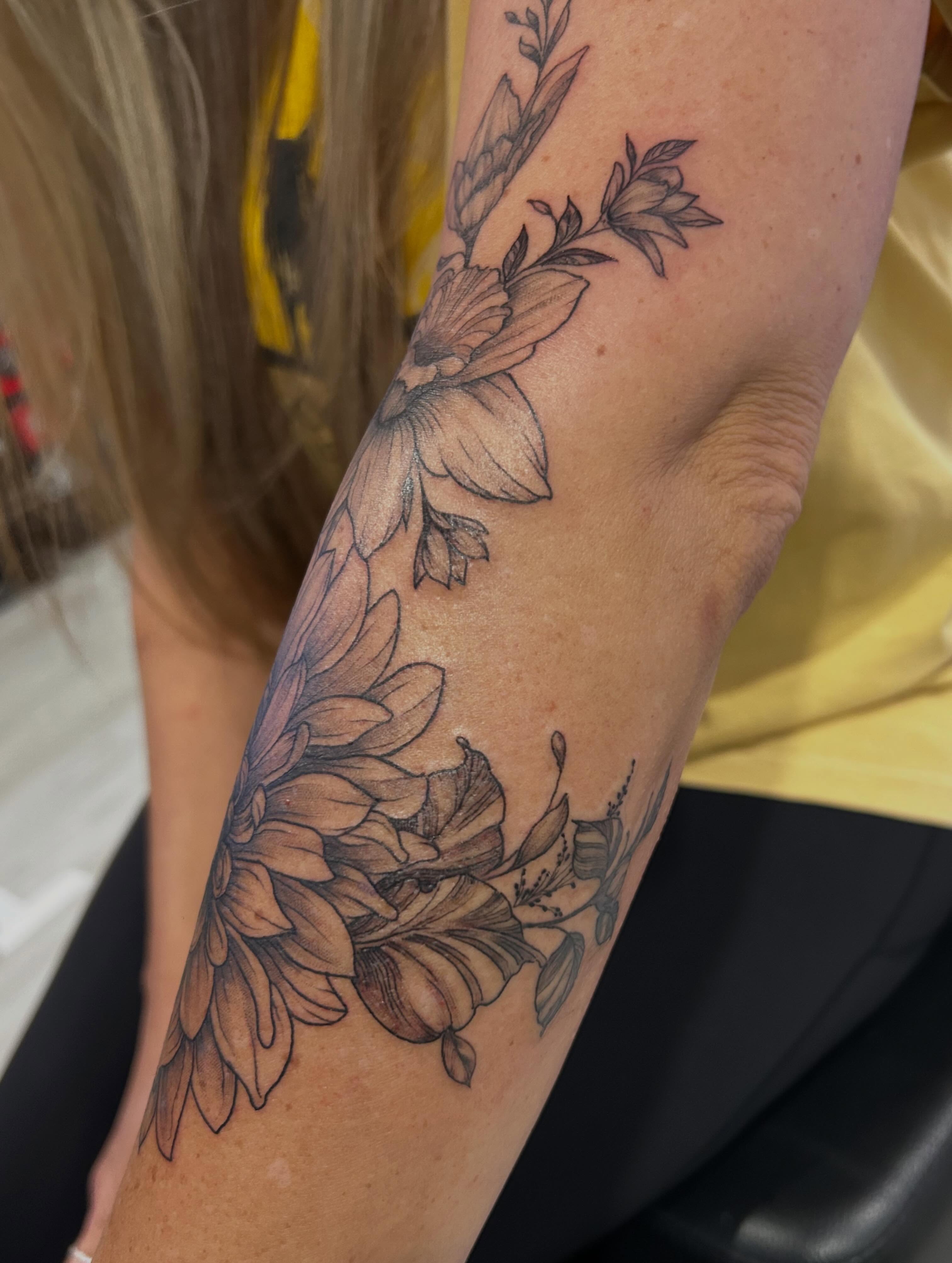 Floral bouquet black and grey tattoo on the forearm by Jbtattoo Artistry
