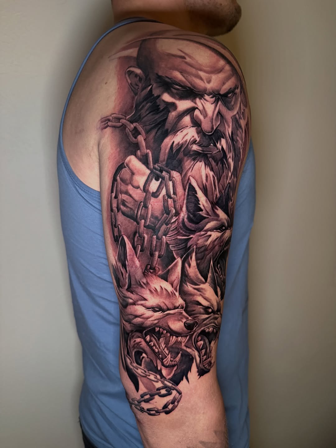 Man with chains and wolves realism tattoo on the forearm by Mike Nance