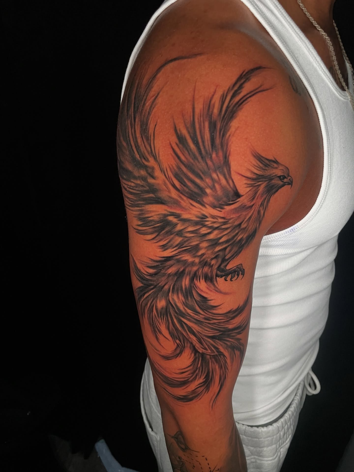 Phoenix black and grey tattoo on the upper arm by Shaunboweink