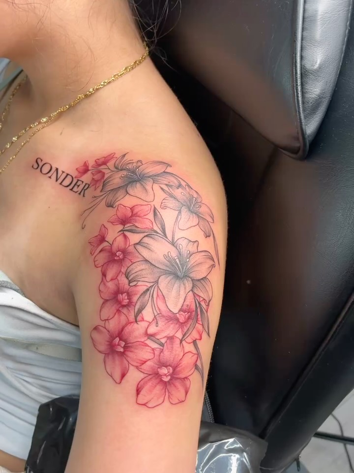 Flowers watercolor tattoo on the shoulder by Tattoos by Hailey