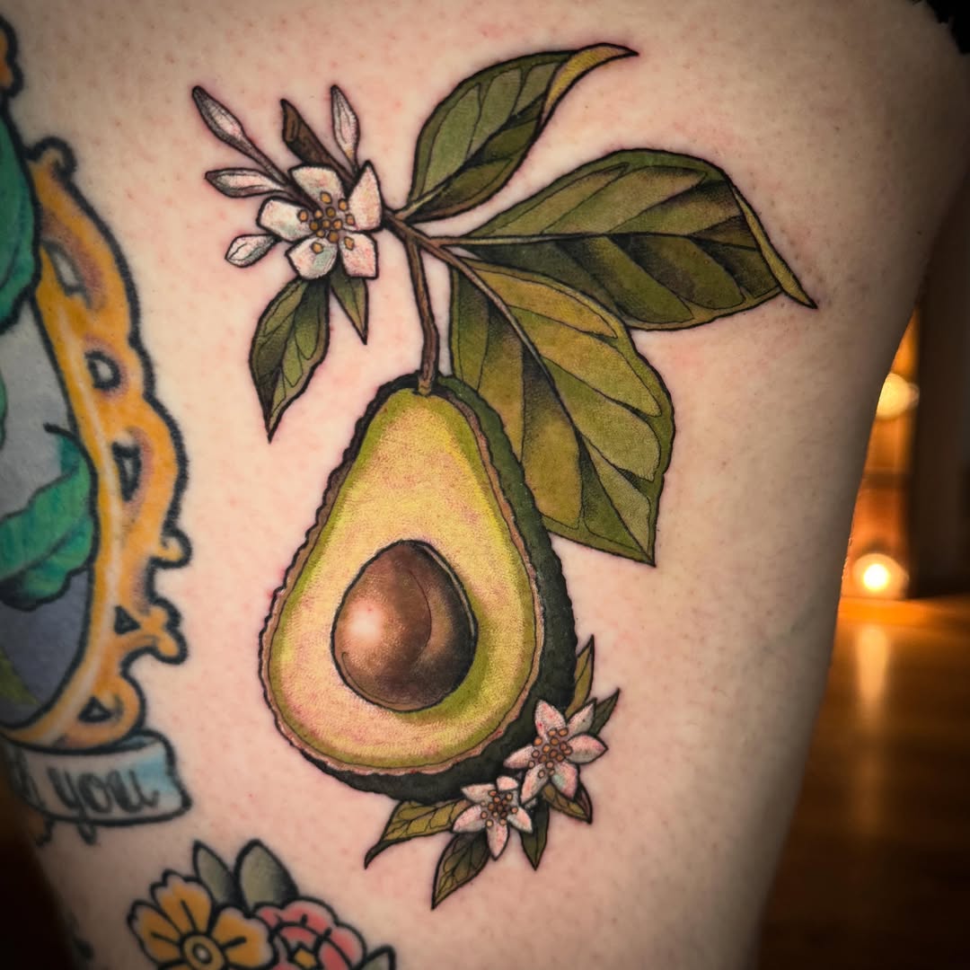 Avocado American traditional tattoo on the thigh by Katy Bisby