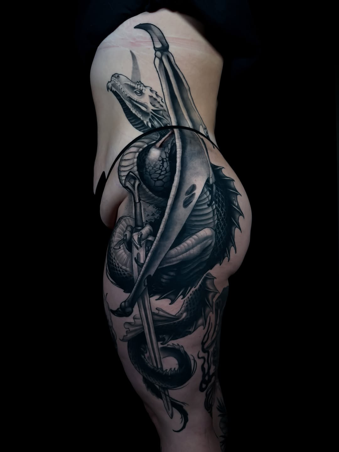 Dragon with sword realism tattoo on the thigh by Carlos Valdes ✨ Tattoo Artist in Tampa FL
