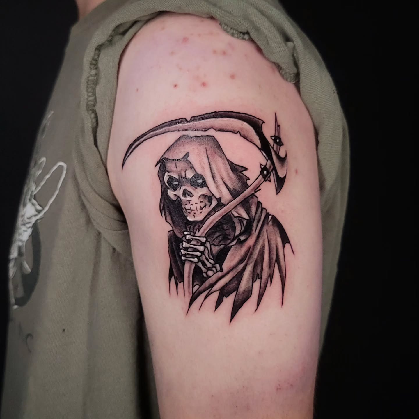 Grim reaper black and grey tattoo on the upper arm by Sarah Alba