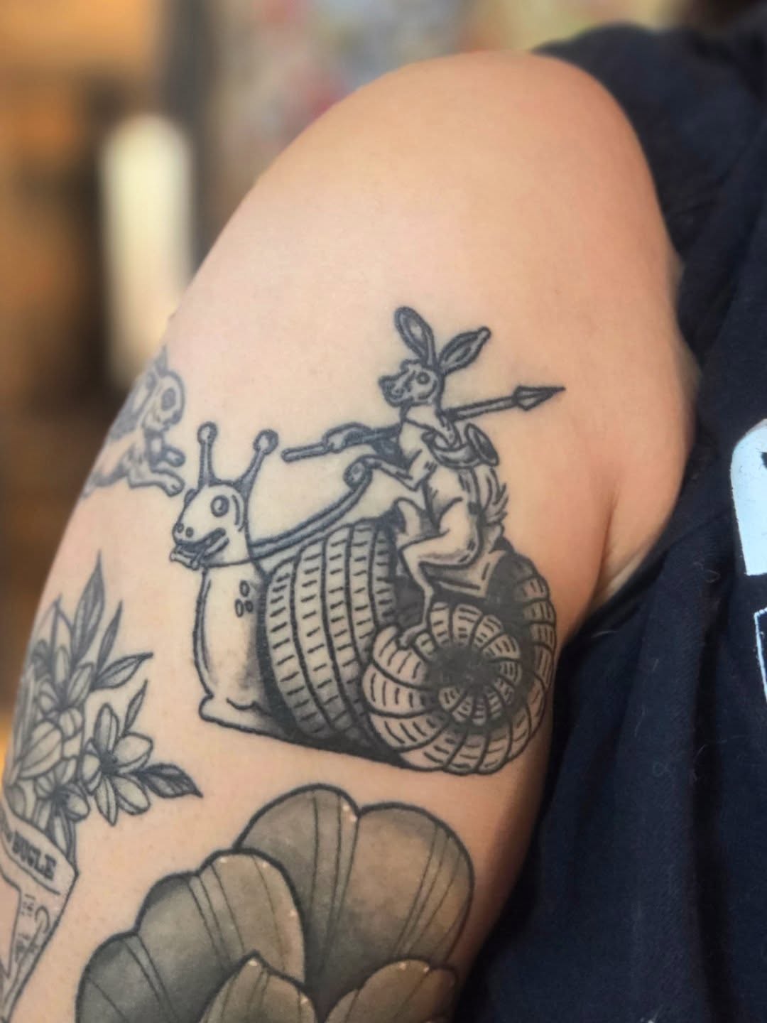 Snail and rabbit American traditional tattoo on the upper arm by Courtney, Lakewood, Ohio
