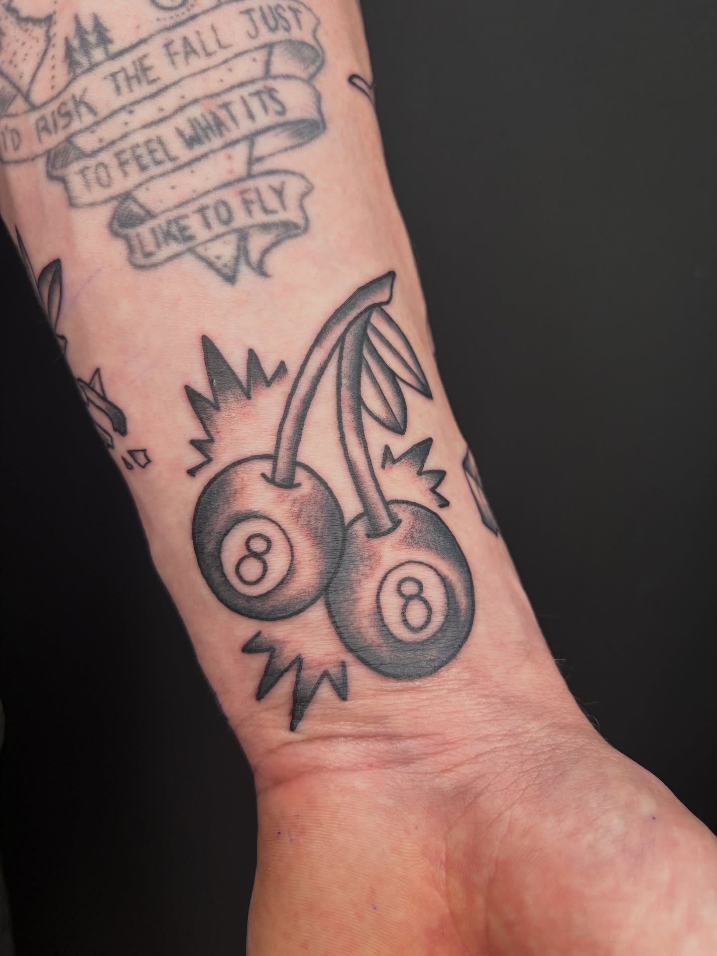 Cherry and eight ball American traditional tattoo on the forearm by Poppy Olivia Deards