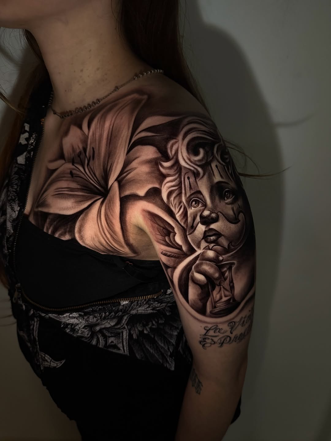 Clown face and lily Chicano tattoo on the shoulder by inkzombi